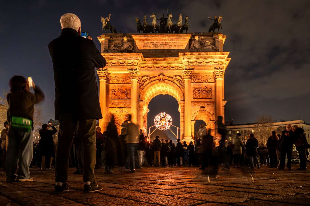 Visitors take photos at the Olympic cauldron of the 2026 Milan Cortina Winter Olympics at the Arco della Pace in Milan, Italy, on Saturday, Feb. 7, 2026.