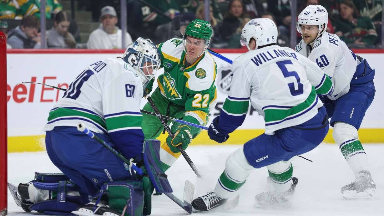 Minnesota Wild right wing Danila Yurov (22) shoots the puck against Vancouver Canucks goaltender Nikita Tolopilo (60) during the first period of an NHL hockey game Thursday, April 2, 2026, in St. Paul, Minn.