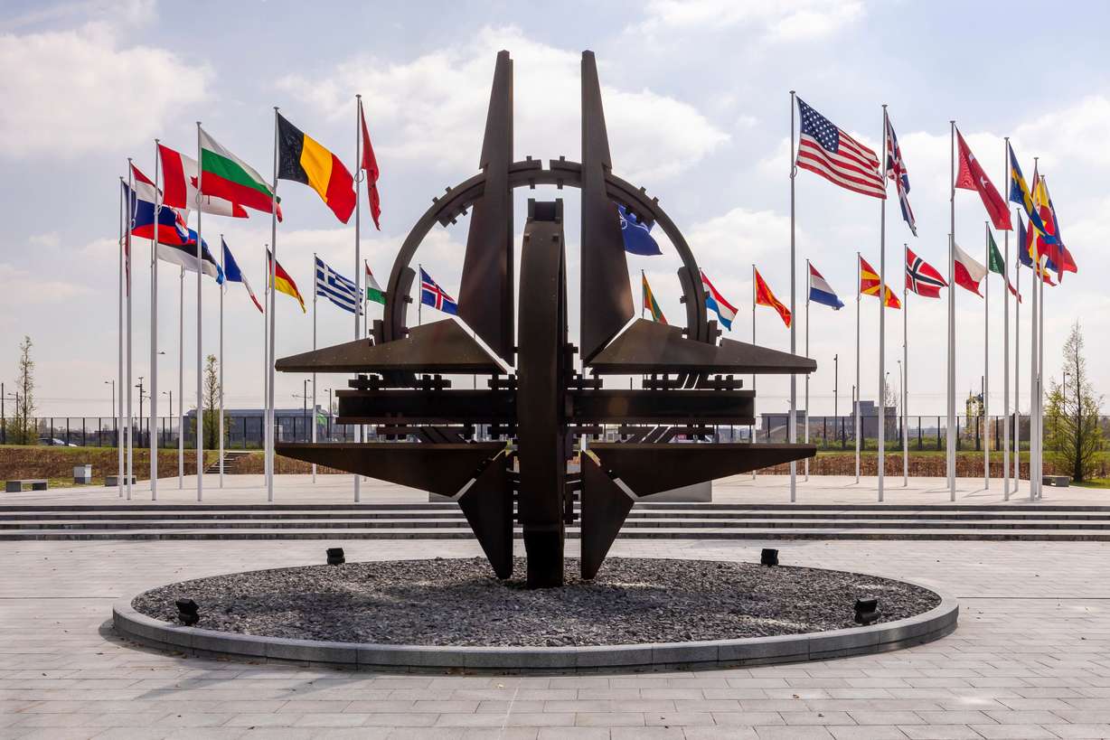 Member flags flap in the wind prior to a "coalition of the willing" defense ministers meeting at NATO headquarters in Brussels, Belgium, April 10, 2025. President Donald Trump on Wednesday threatened to pull the U.S. out of the alliance over the Iran war.