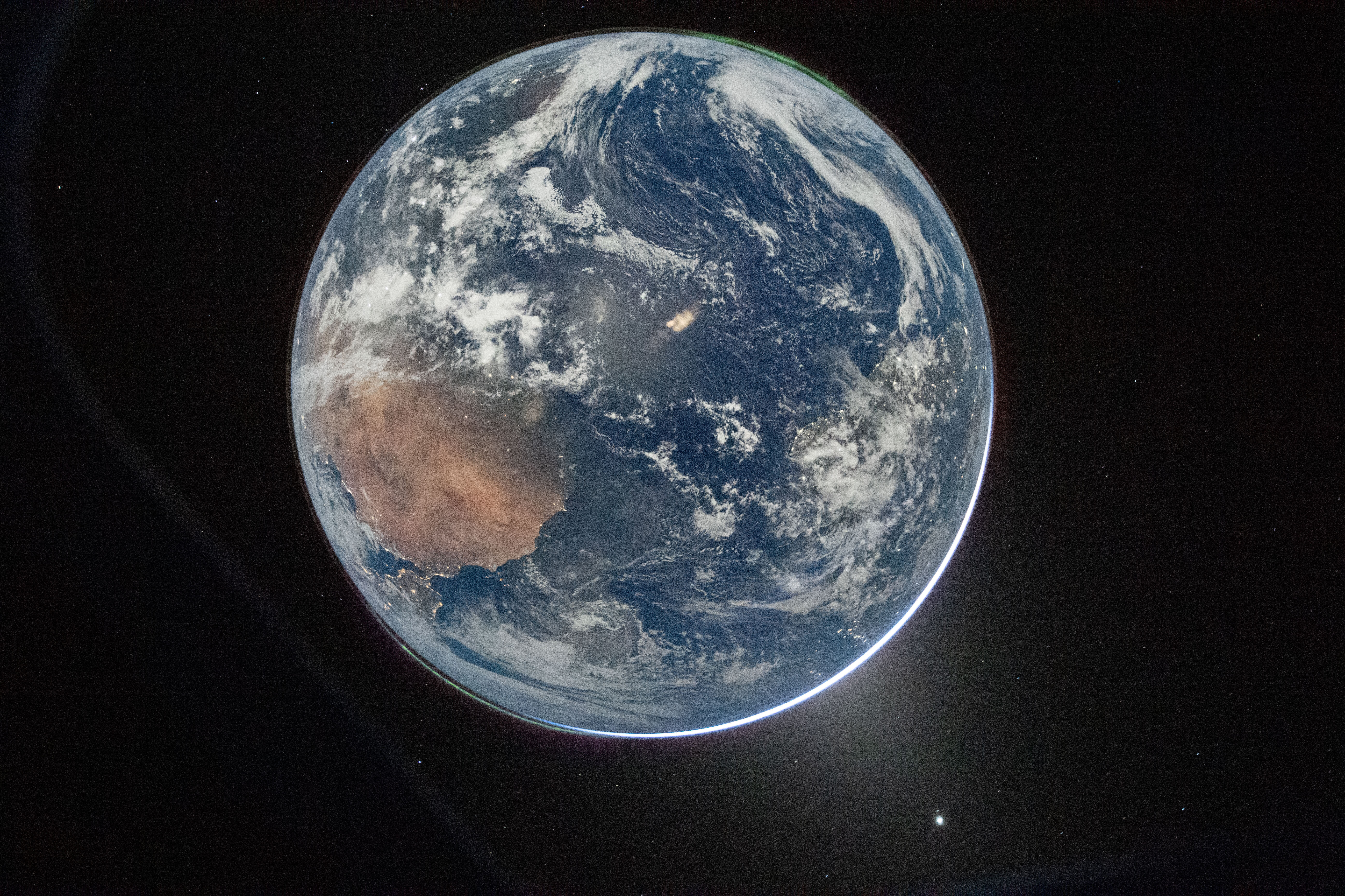 This image provided by NASA shows a view of Earth taken by NASA astronaut and Artemis II Commander Reid Wiseman from of the Orion spacecraft's window after completing the translunar injection burn on Thursday.