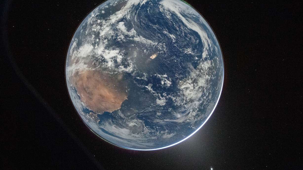 This image provided by NASA shows a view of Earth taken by NASA astronaut and Artemis II Commander Reid Wiseman from of the Orion spacecraft's window after completing the translunar injection burn on Thursday.