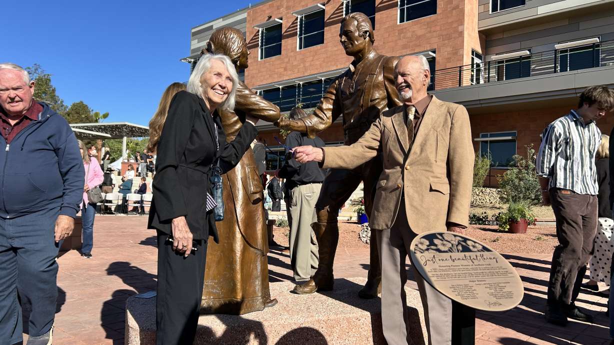 Artist Jerry Anderson poses with wife of 71 years, Fawn Anderson. He created a sculpture titled Just One Beautiful Thing that was unveiled at the grand opening of City Hall Plaza in St. George Friday.