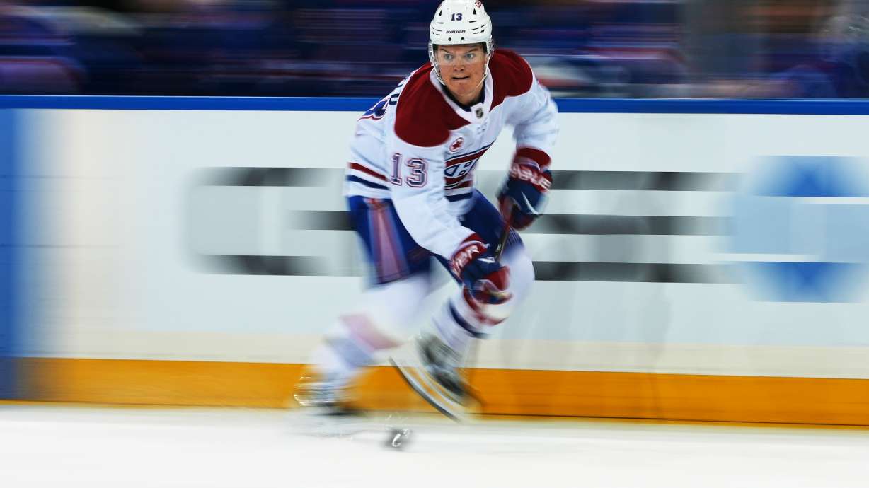 Montréal Canadiens' Cole Caufield (13) drives toward the net during the third period of an NHL hockey game against the New York Rangers Thursday, April 2, 2026, in New York.