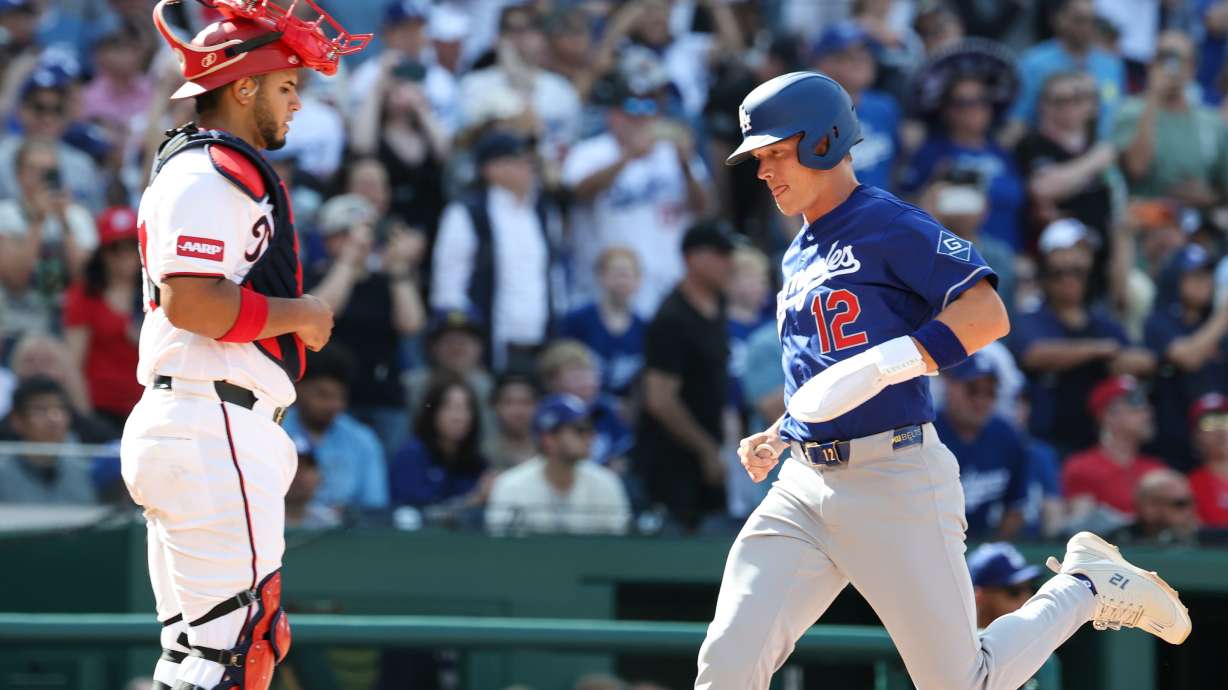 Los Angeles Dodgers' Alex Call (12) scores a run on a sacrifice fly hit by Shohei Ohtani off Washington Nationals pitcher Andre Granillo (not shown) during the ninth inning of a baseball game, Friday, April 3, 2026, in Washington.