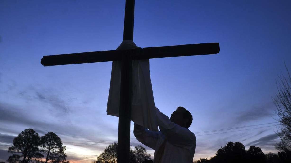 Rev. Bill Barksdale puts a cloth on a cross before the start of an Easter Sunday sunrise service at St. Andrew's United Methodist Church in Oxford, Miss., on April 5, 2015. Many will look for ways to focus on Jesus through music.