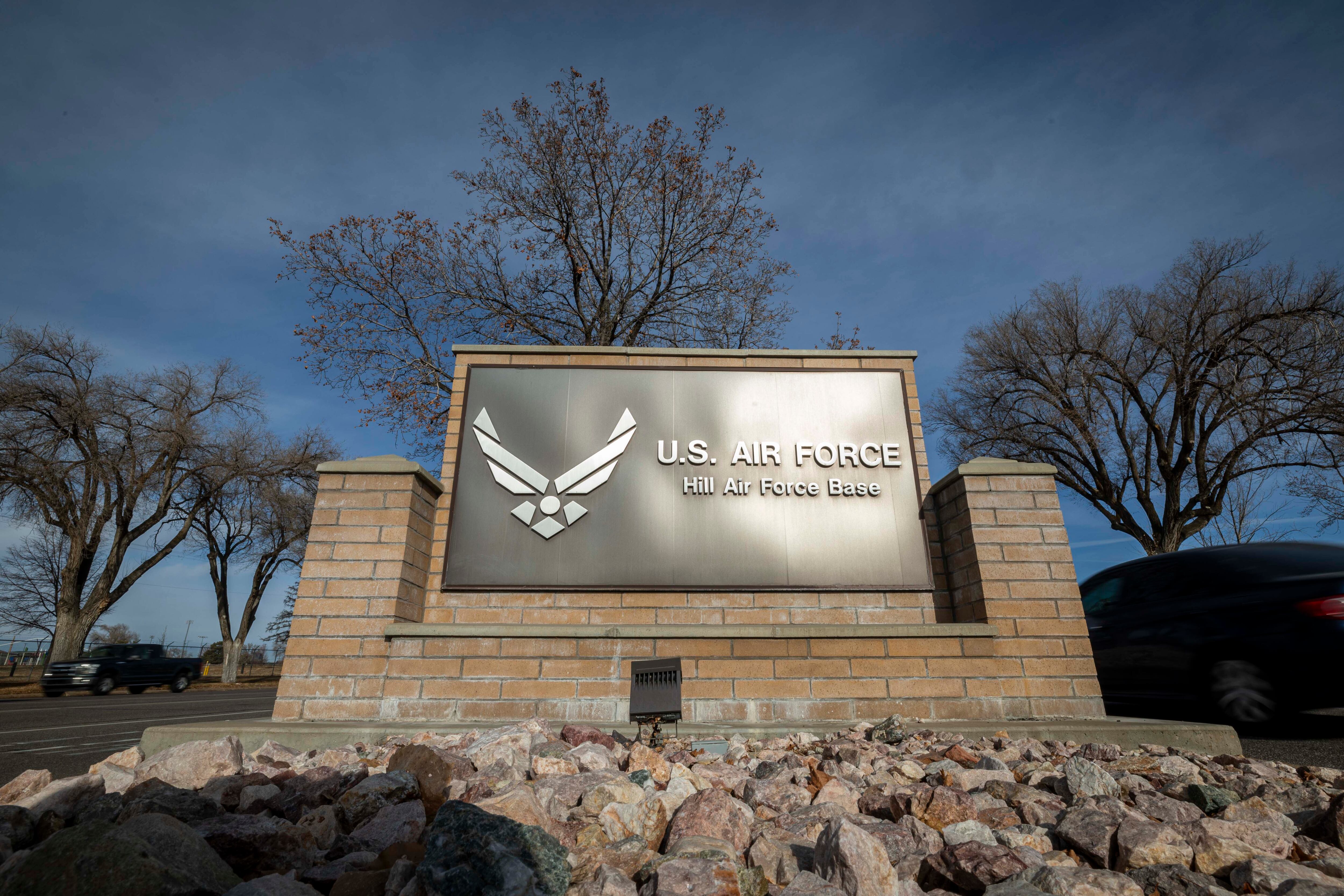 Traffic flows past a sign at the south gate of Hill Air Force Base northeast of Clearfield on Dec. 11, 2024. Hill Air Force Base warned drone users of flying over military airspace, claiming it poses a danger to military personnel.
