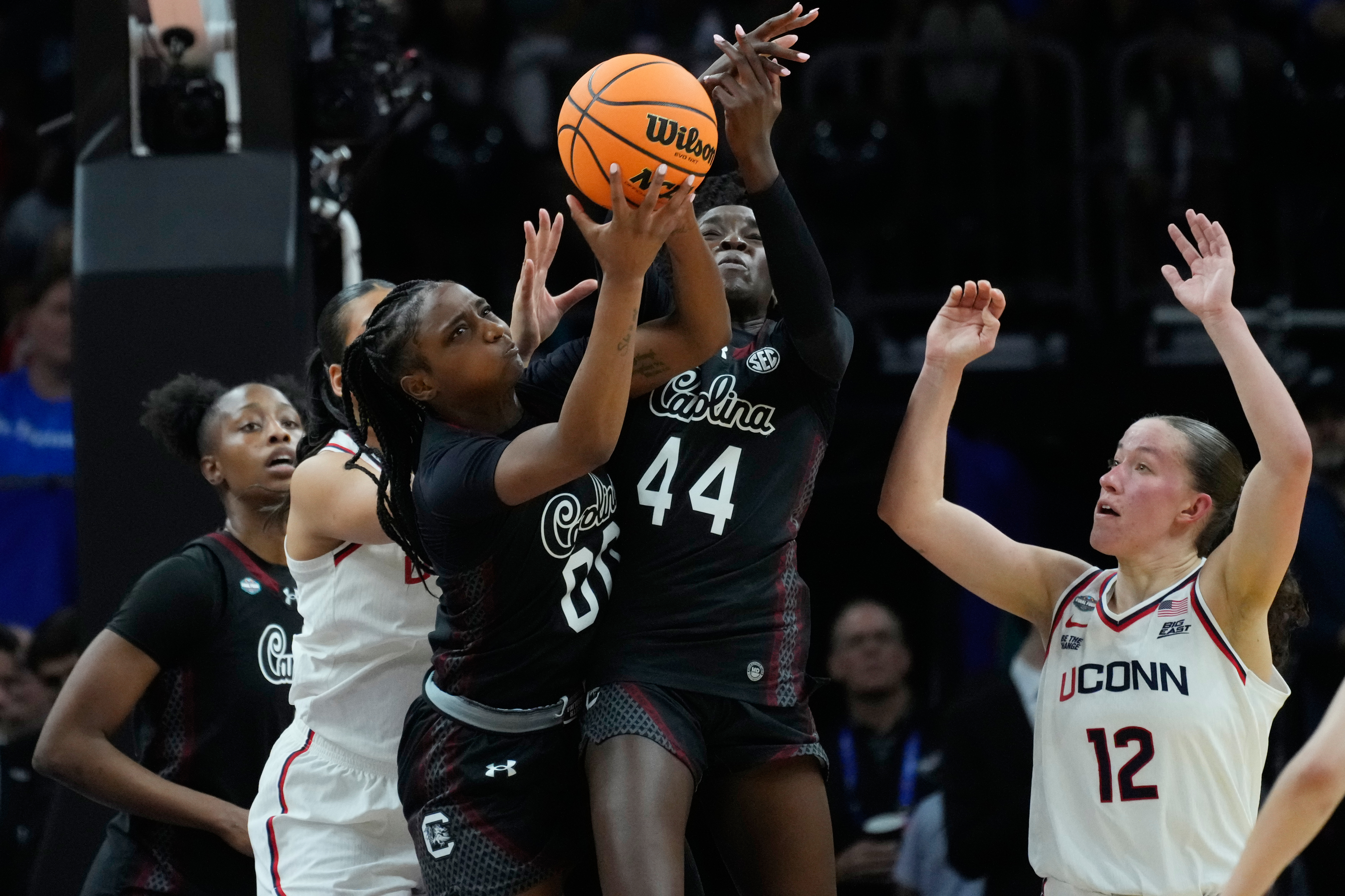South Carolina guard Ta'Niya Latson (00) and South Carolina guard Agot Makeer (44) go for a rebound against UConn during the first half of a woman's NCAA college basketball tournament semifinal game at the Final Four, Friday, April 3, 2026, in Phoenix.