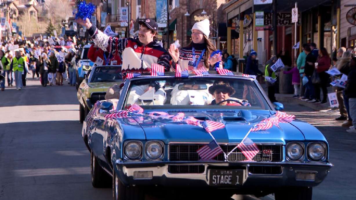 Utahns and Olympic lugers Matt Greiner and Ashley Farquharson wave to the crowd in a welcome home parade in Park City, Friday. Utah's Olympians and Paralympians received an official warm welcome home from the 2026 Winter Olympics.