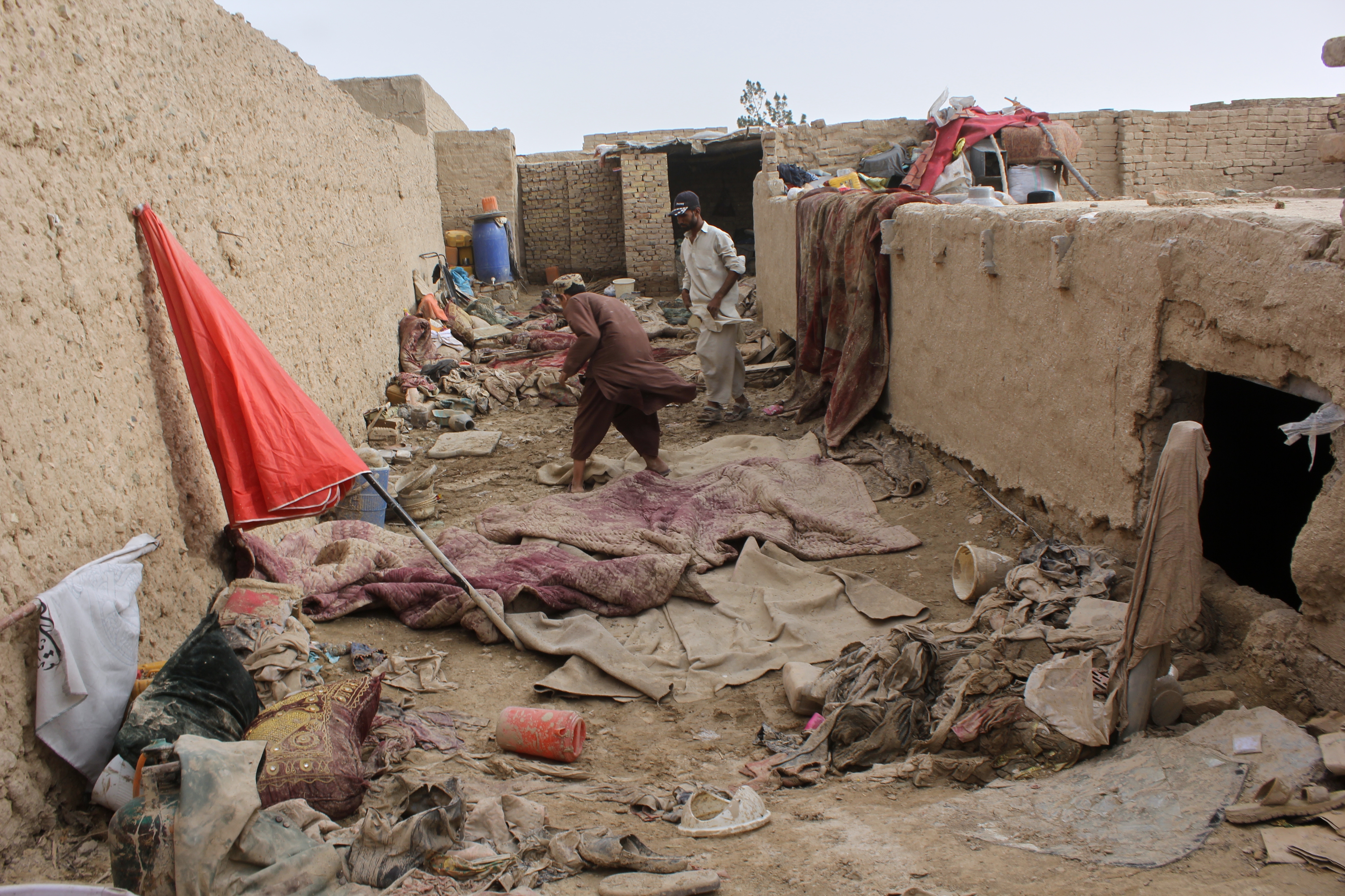 Locals inspect a damaged house following floods, landslides and thunderstorms in Kandahar province, Afghanistan, March 29.