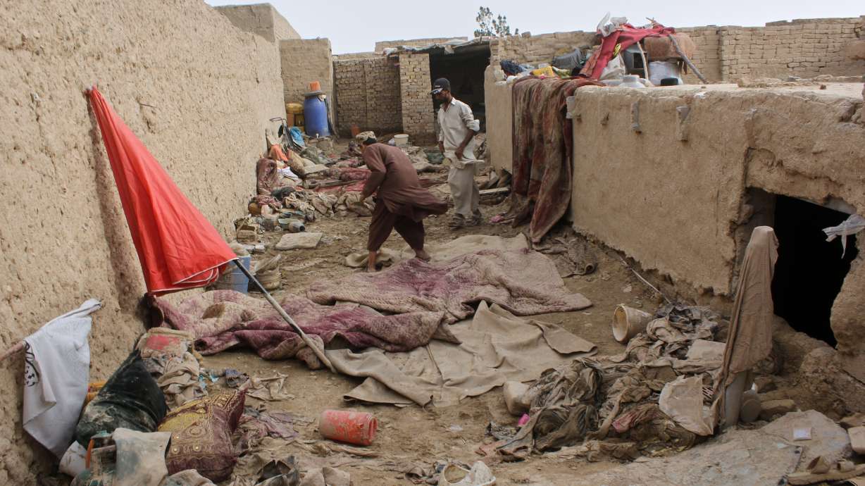 Locals inspect a damaged house following floods, landslides and thunderstorms in Kandahar province, Afghanistan, March 29.