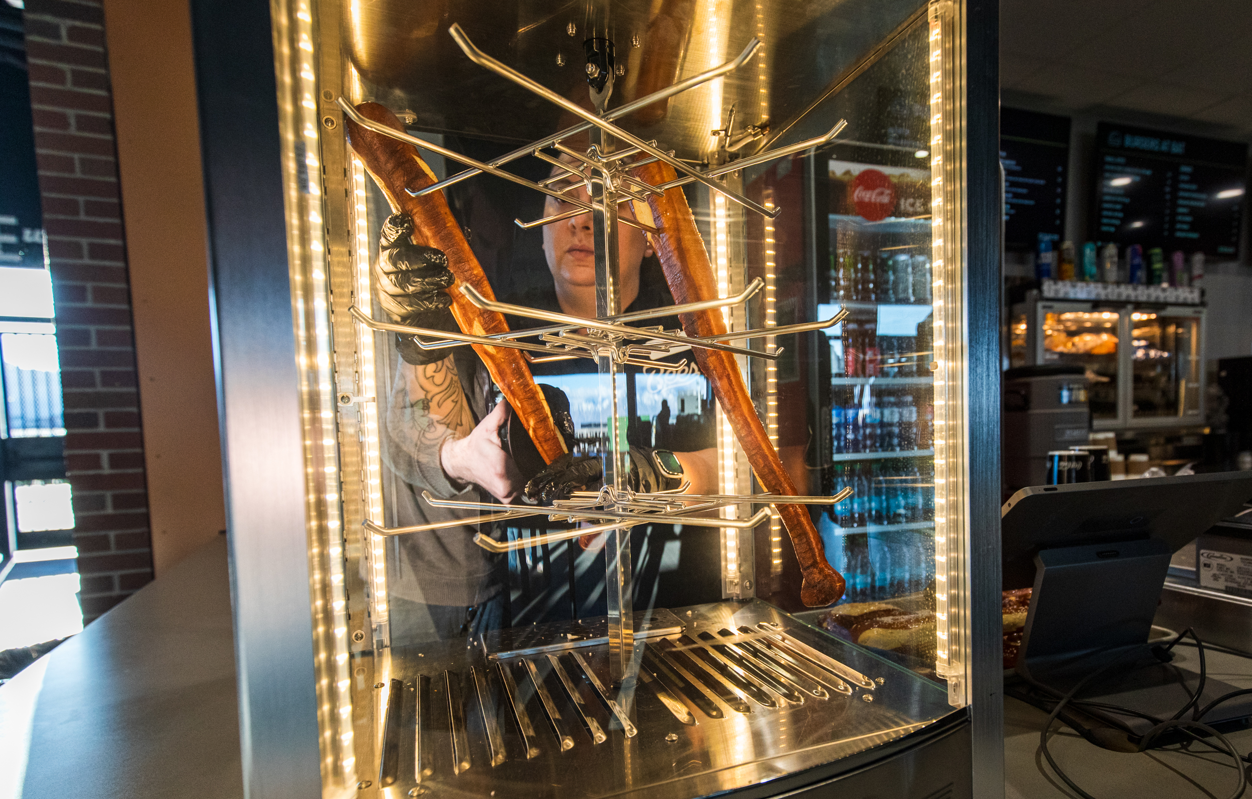 An employee at Burgers at Bat stocks new pretzel bats during a Salt Lake Bees game at The Ballpark at America First Square in South Jordan on Friday. It's one of the stadium's new food items this year.