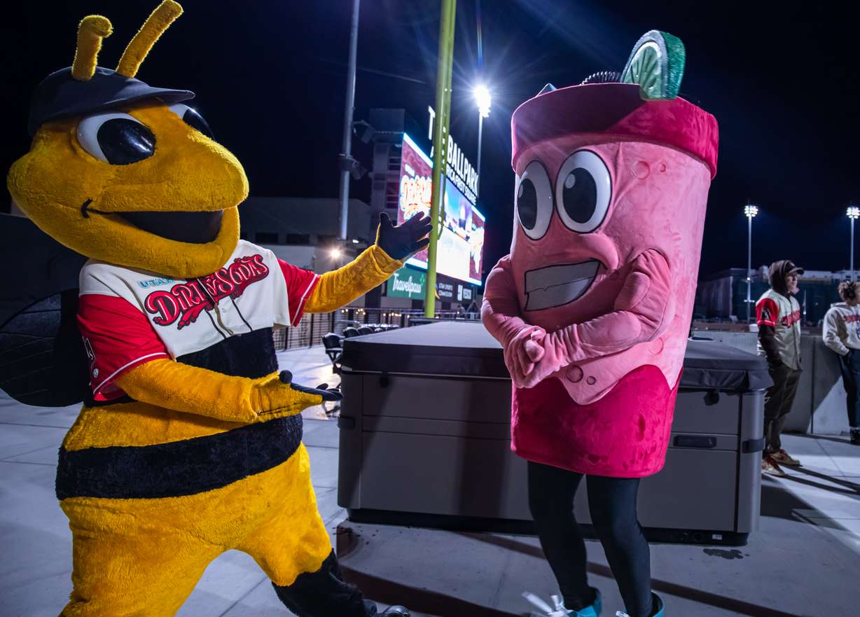 Salt Lake Bees mascot Bumble, left, introduces Utah Dirty Sodas mascot Swigg, right, during the first Utah Dirty Sodas game at The Ballpark at America First Square on Wednesday, April 1, 2026.