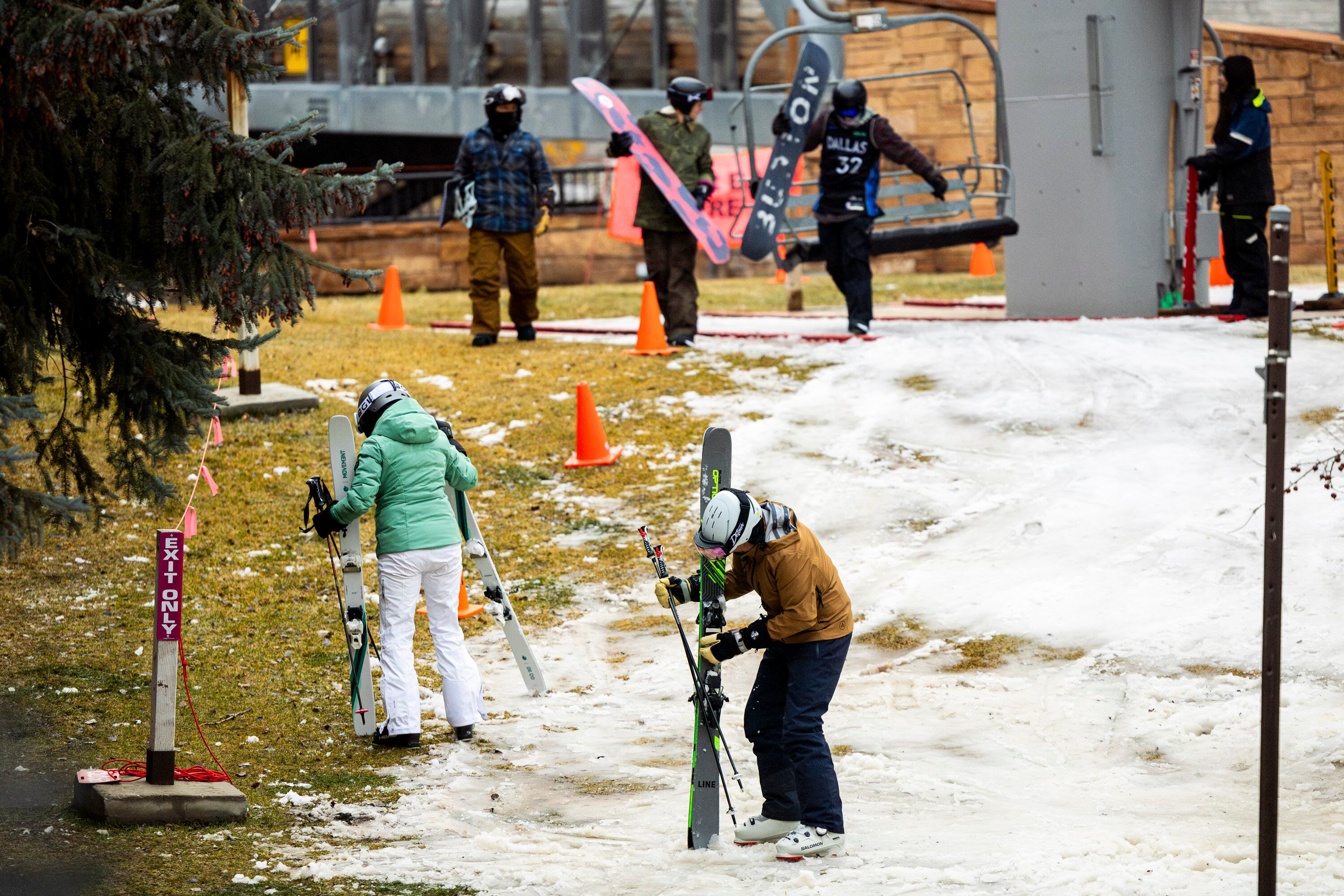 Skiers and snowboarders exit Park City Mountain Resort’s Town Lift along Main Street in Park City on Jan. 2. A lawsuit over daily lift ticket prices against the resort's owner comes as the West experiences its lowest snowfall ever.