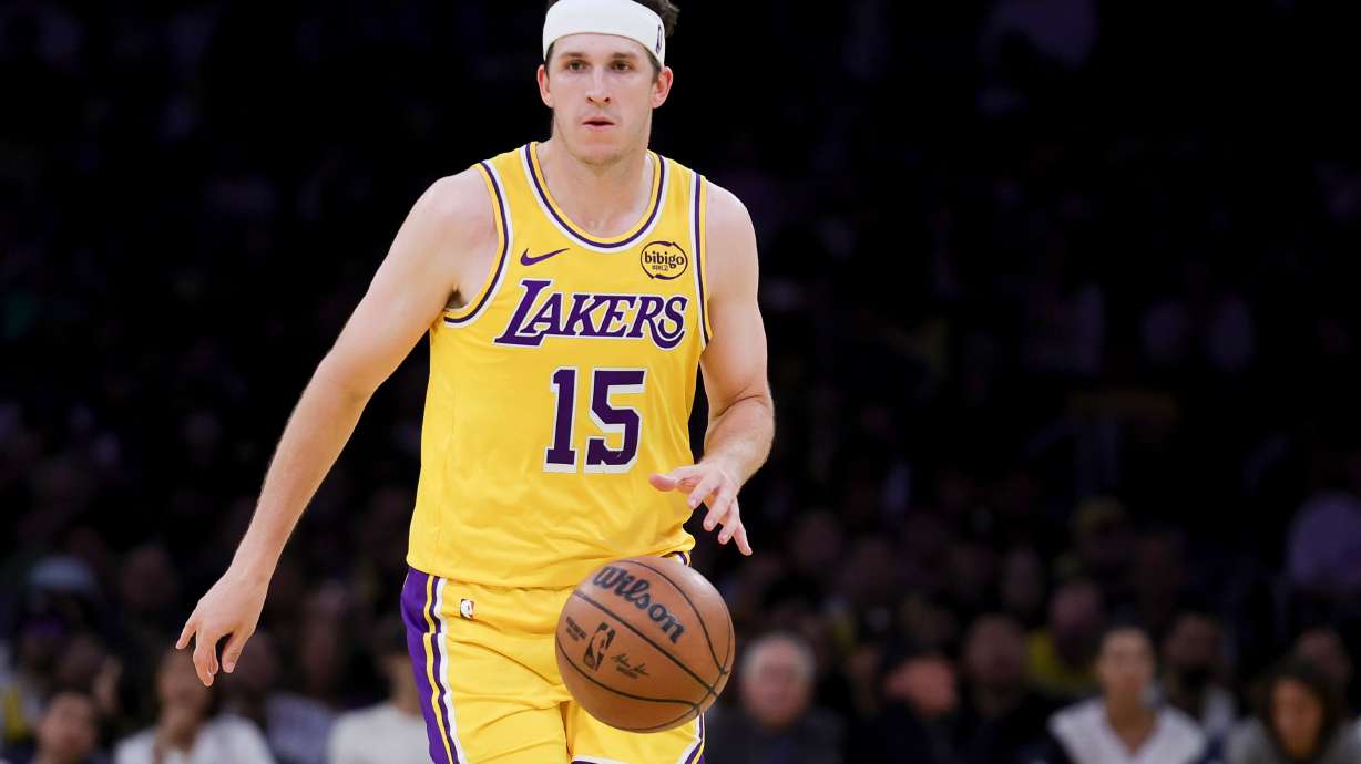 Los Angeles Lakers guard Austin Reaves brings the ball up court during the second half of an NBA basketball game against the Washington Wizards Monday, March 30, 2026, in Los Angeles.