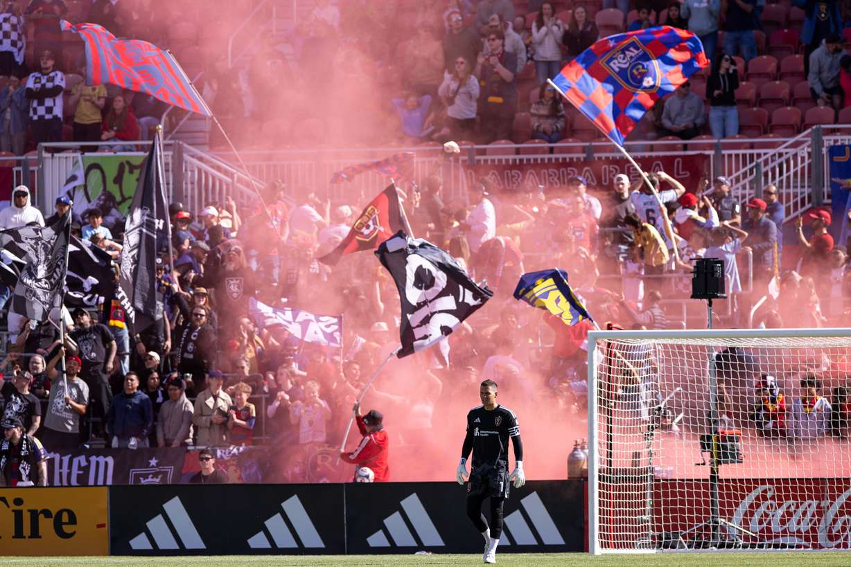 The Real Salt Lake Riot wave flags as they celebrate RSL’s third goal of the game during the second half of an MLS game against Sporting Kansas City at America First Field in Sandy on Saturday, April 4, 2026.
