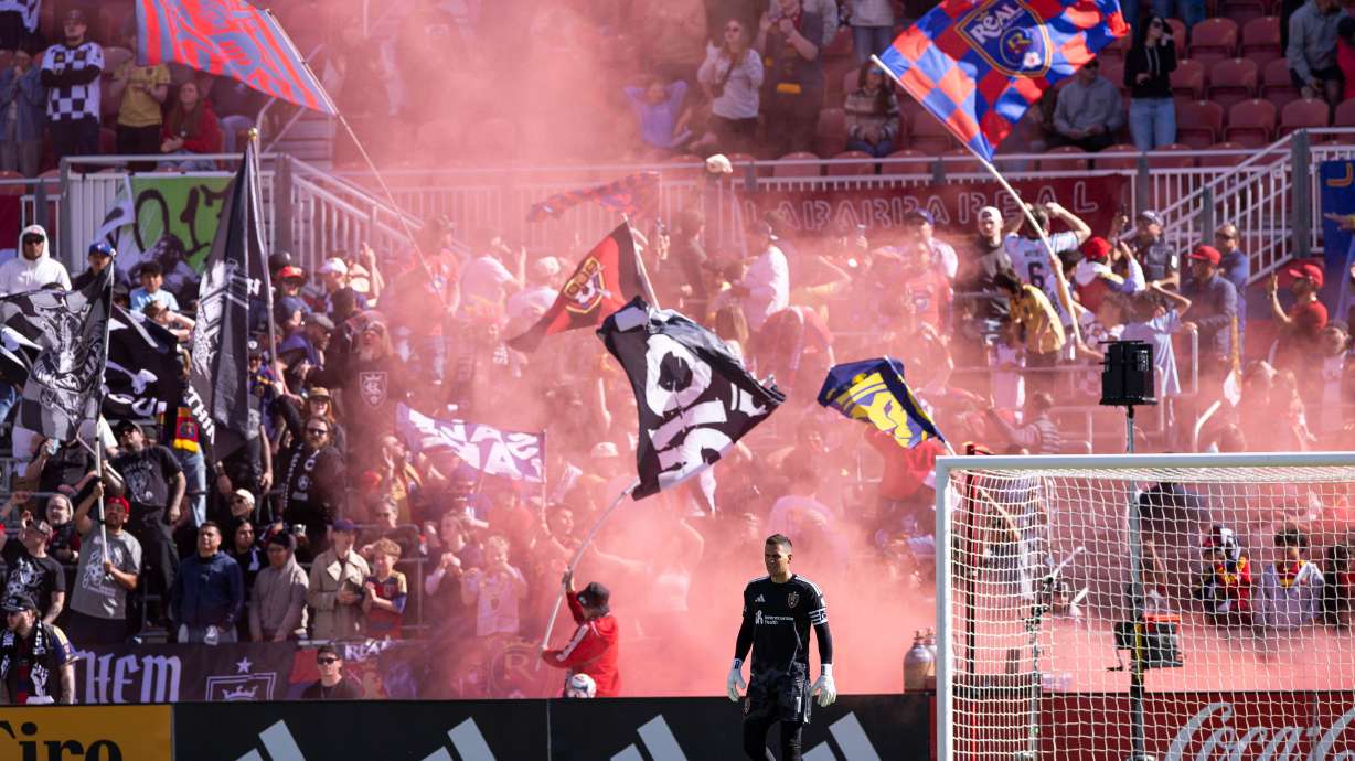 The Real Salt Lake Riot wave flags as they celebrate RSL’s third goal of the game during the second half of an MLS game against Sporting Kansas City at America First Field in Sandy on Saturday, April 4, 2026.