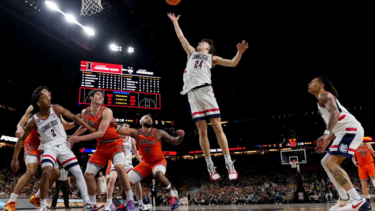 UConn guard Braylon Mullins (24) rebounds against Illinois during the second half of an NCAA college basketball tournament semifinal game at the Final Four, Saturday, April 4, 2026, in Indianapolis.