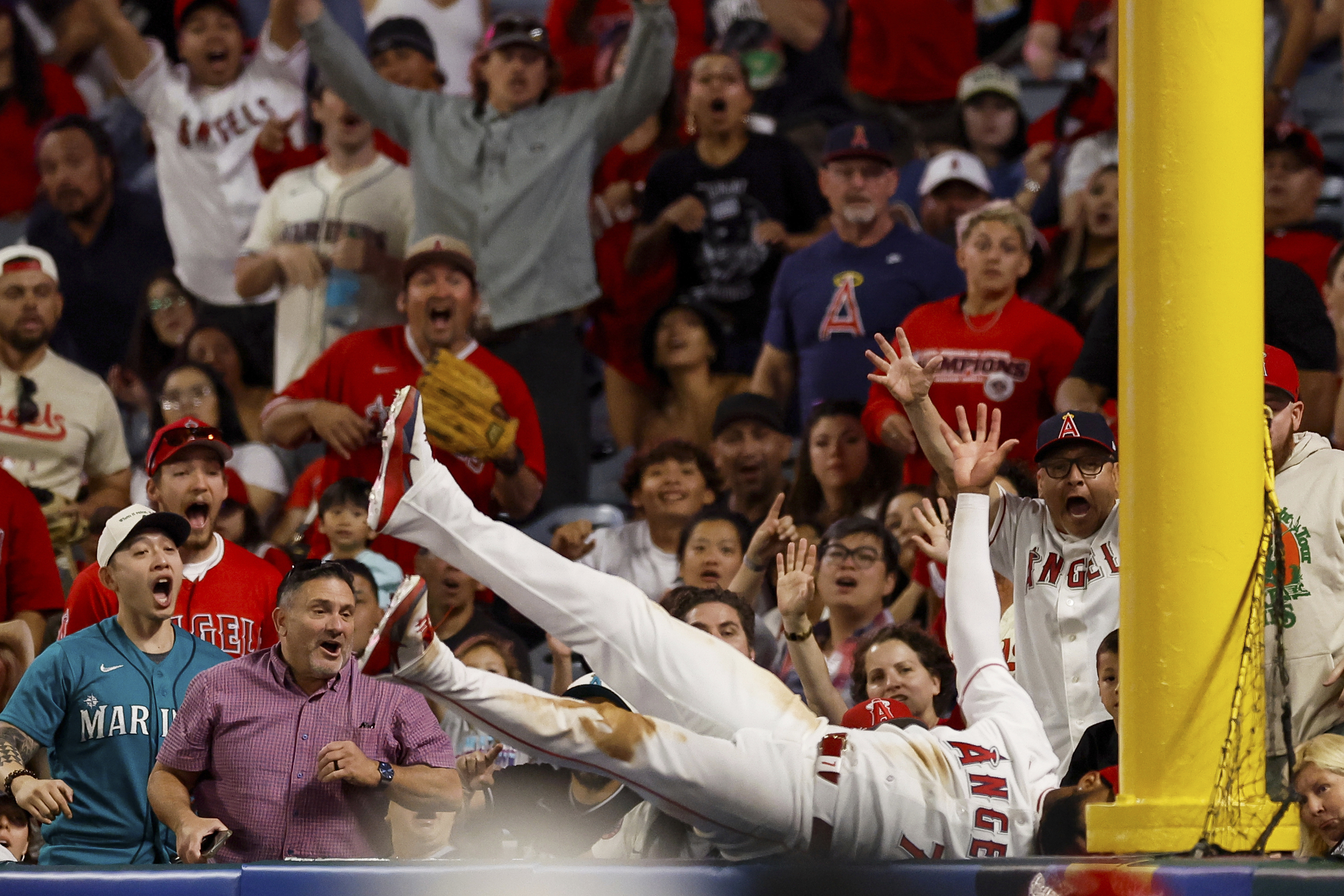 Los Angeles Angels left fielder Jo Adell (7) catches a ball hit by Seattle Mariners' J.P. Crawford during the ninth inning of a baseball game Saturday, April 4, 2026, in Anaheim, Calif.