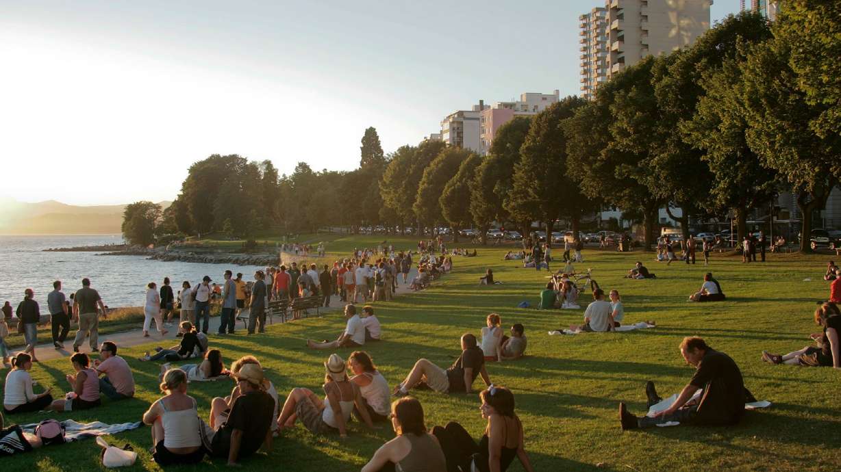 Crowds gather for a sunset at English Bay Beach in Vancouver in the Canadian province of British Columbia. Vancouver leaders approved a resolution on Wednesday that initiates their bid for an MLB expansion team.