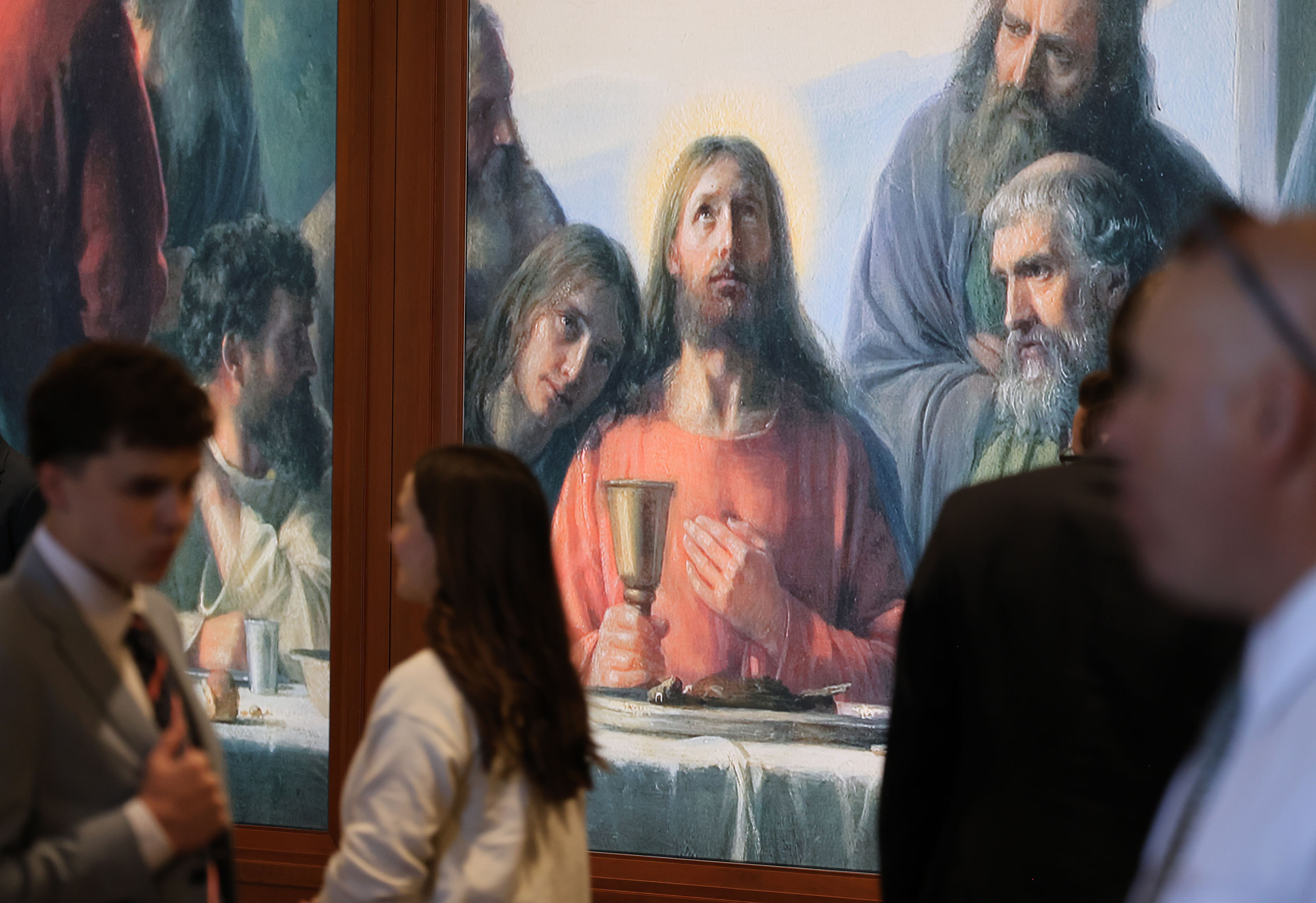 Attendees walk into the 196th Annual General Conference of The Church of Jesus Christ of Latter-day Saints at the Conference Center in Salt Lake City on Sunday.