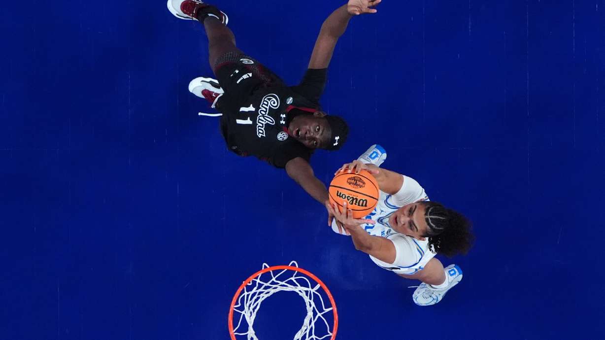 UCLA center Lauren Betts, right, and South Carolina center Madina Okot (11) battle for a rebound during the first half of the women's National Championship Final Four NCAA college basketball tournament game, Sunday, April 5, 2026, in Phoenix.