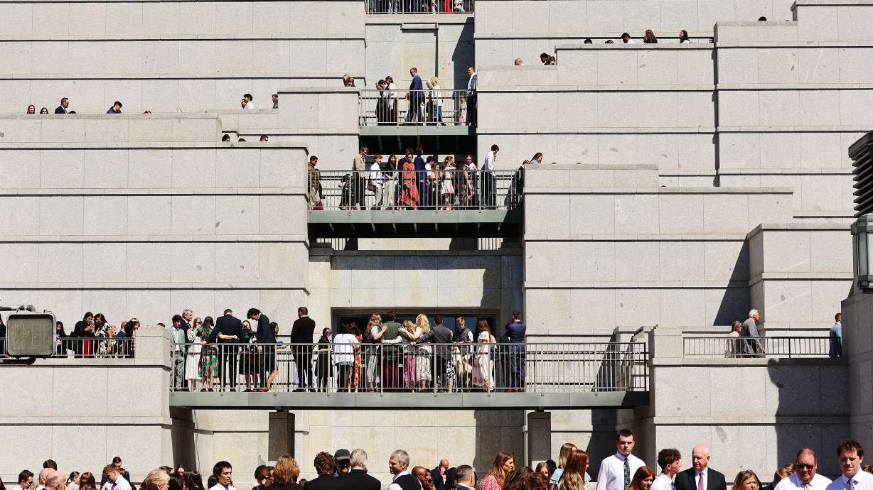 Attendees leave the Conference Center after a general conference session Sunday in Salt Lake City. A man was arrested on Saturday after police say he stripped naked in front of thousands who had gathered for the event.