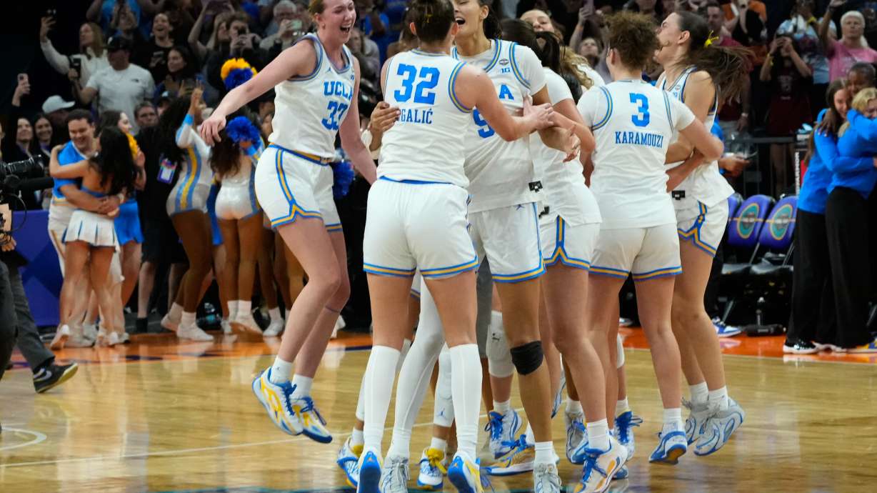 UCLA players celebrate after defeating South Carolina in the women's National Championship Final Four NCAA college basketball tournament game, Sunday, April 5, 2026, in Phoenix.