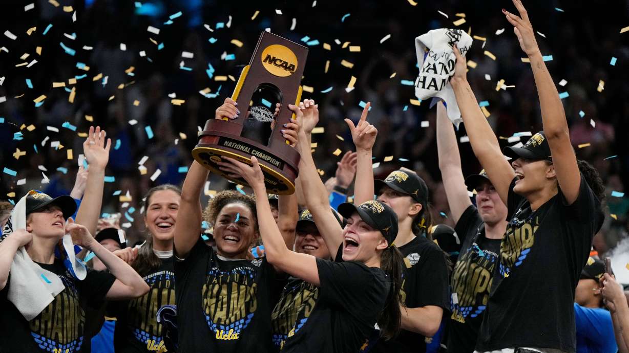 UCLA players celebrate after defeating South Carolina in the women's National Championship Final Four NCAA college basketball tournament game, Sunday, April 5, 2026, in Phoenix.