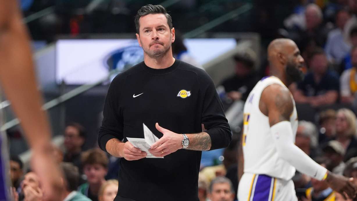 Los Angeles Lakers head coach JJ Redick walks onto the court during a time out in the first half of an NBA basketball game against the Dallas Mavericks in Dallas, Sunday, April 5, 2026.