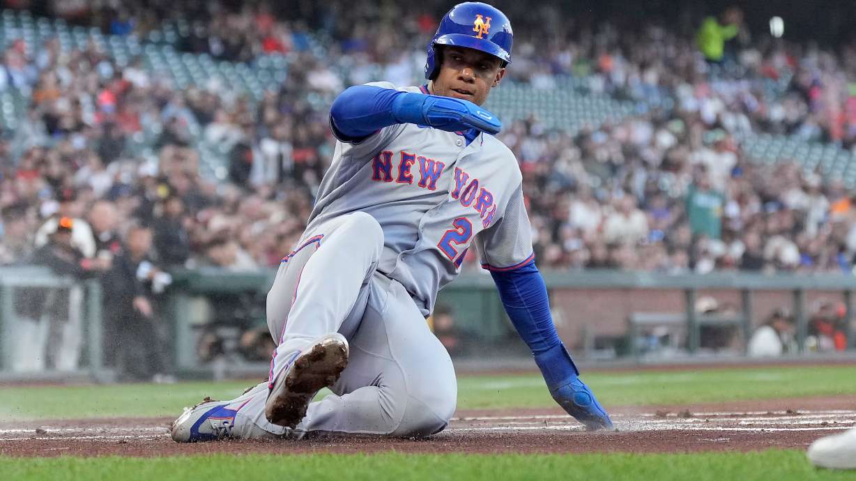 New York Mets' Juan Soto slides into home plate to score on a double by Bo Bichette during the first inning of a baseball game against the San Francisco Giants in San Francisco, Thursday, April 2, 2026.