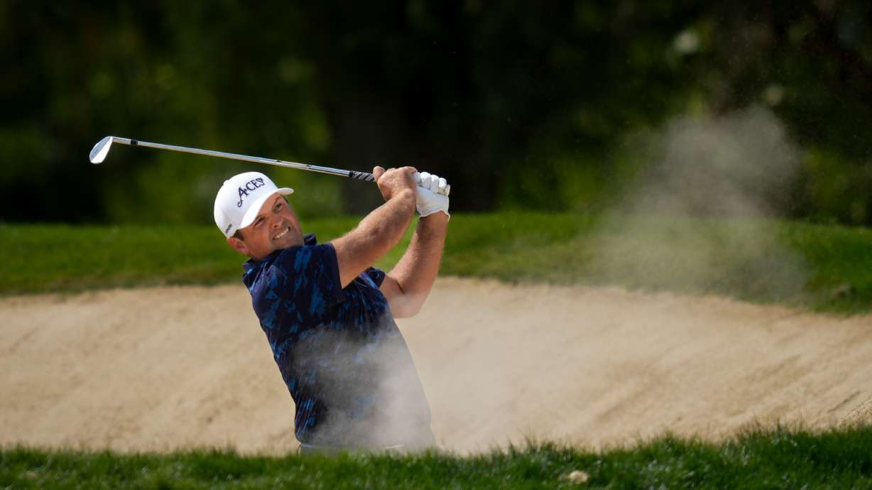 FILE - Patrick Reed, of the United States, hits a shot from a bunker on the first hole during the third round of the Dubai Desert Classic golf tournament in Dubai, United Arab Emirates, Jan. 24, 2026.