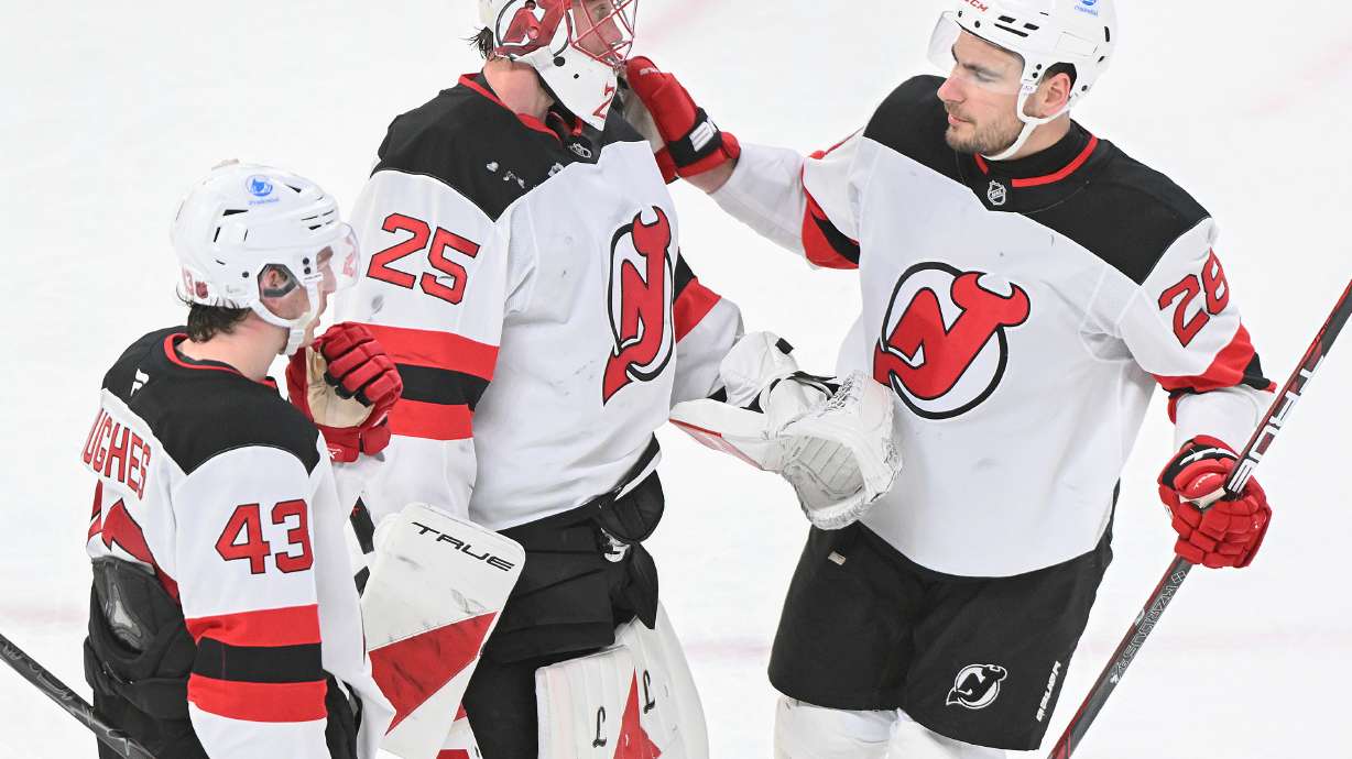 New Jersey Devils goaltender Jacob Markstrom (25), Timo Meier (28) and Luke Hughes (43) celebrate their win over the Montreal Canadiens in an NHL hockey game in Montreal, Sunday, April 5, 2026.