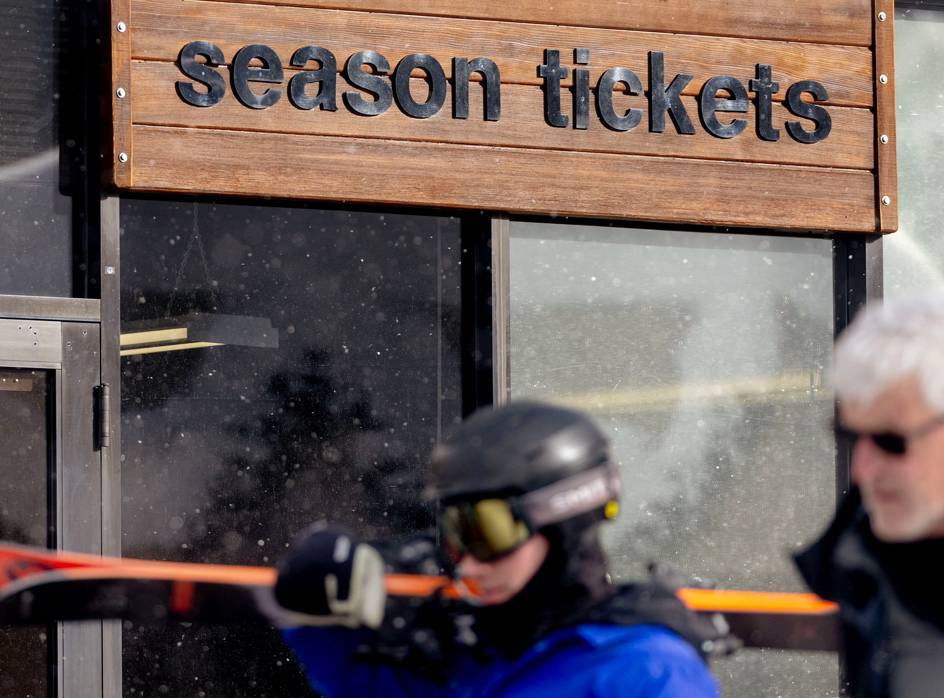 People walk past a ticket booth at Snowbird in Little Cottonwood Canyon on Friday. Daily lift ticket prices have been rising, almost forcing users to buy season passes.