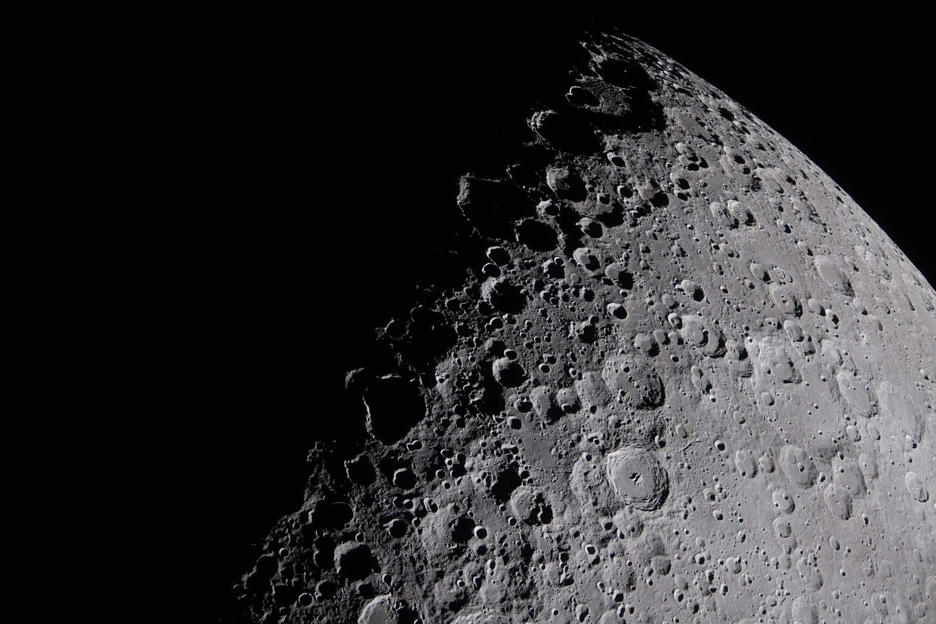 The Artemis II crew captures a portion of the moon coming into view along the terminator – the boundary between lunar day and night – where low-angle sunlight casts long, dramatic shadows across the surface.