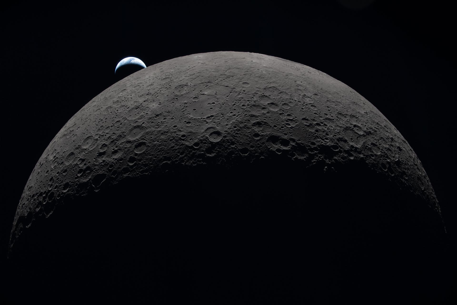 Earth sets at 6:41 p.m. EDT, April 6, over the moon’s curved limb in this photo captured by the Artemis II crew during their journey around the far side of the moon.