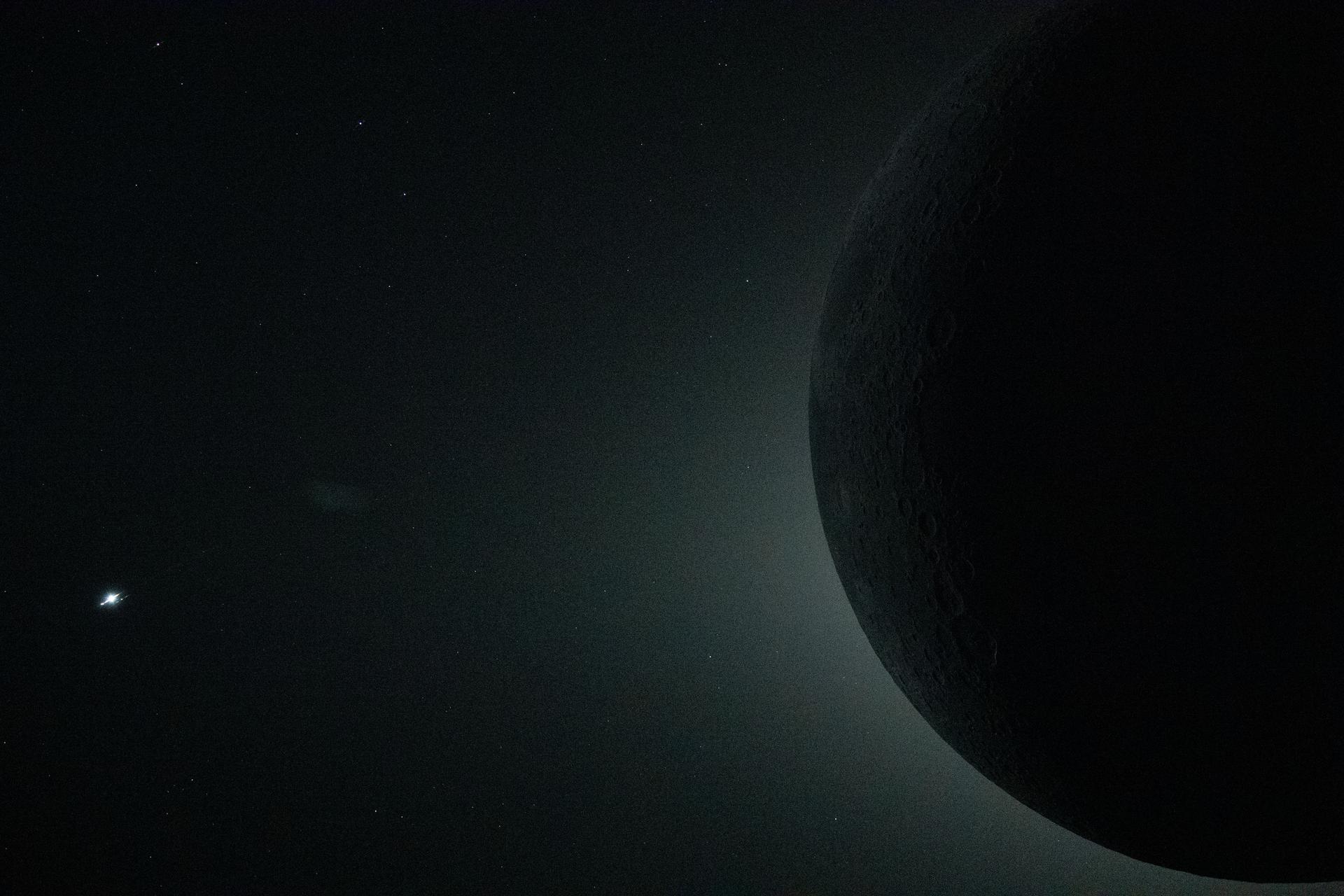 A close-up view from the Orion spacecraft during the Artemis II crew’s lunar flyby on April 6 captures a total solar eclipse, with only part of the moon visible in the frame as it fully obscures the sun.