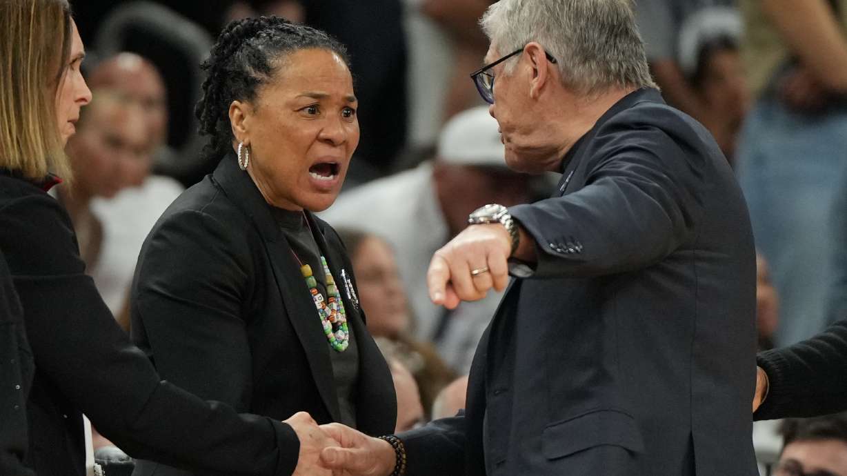 South Carolina head coach Dawn Staley, center, and UConn head coach Geno Auriemma argue after a woman's NCAA college basketball tournament semifinal game at the Final Four, Friday, April 3, 2026, in Phoenix.