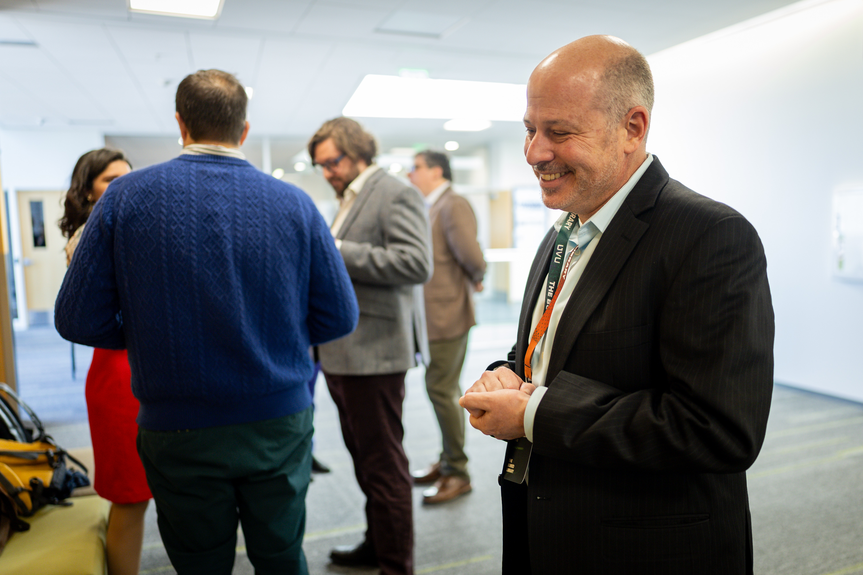 Michael Shaw, professor of philosophy at UVU, right, talks to conferencegoers as part of The Buried Library, an international Herculaneum Papyri and AI Conference, at UVU in Orem on Tuesday.