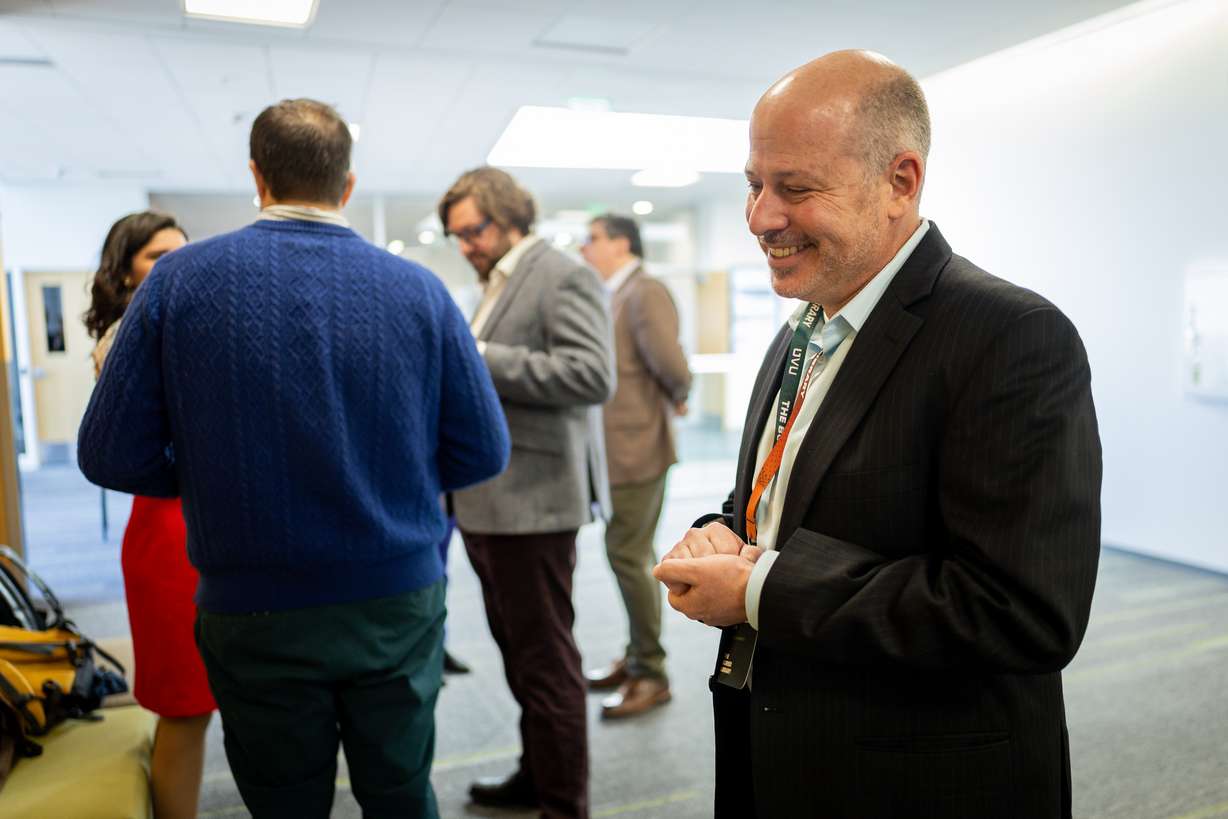 Michael Shaw, professor of philosophy at UVU, right, talks to conferencegoers as part of The Buried Library, an international Herculaneum Papyri and AI Conference, at UVU in Orem on Tuesday.
