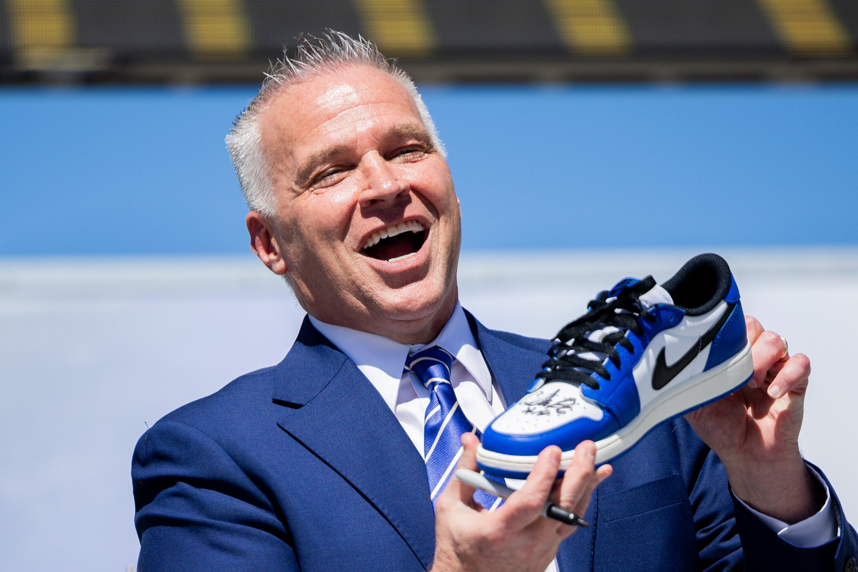 BYU President Shane Reese signs one of his shoes before putting it inside a time capsule during a time capsule packing party as part of BYU’s 150th anniversary celebration at Brigham Square in Provo on Tuesday. The capsule will be opened in 2075.