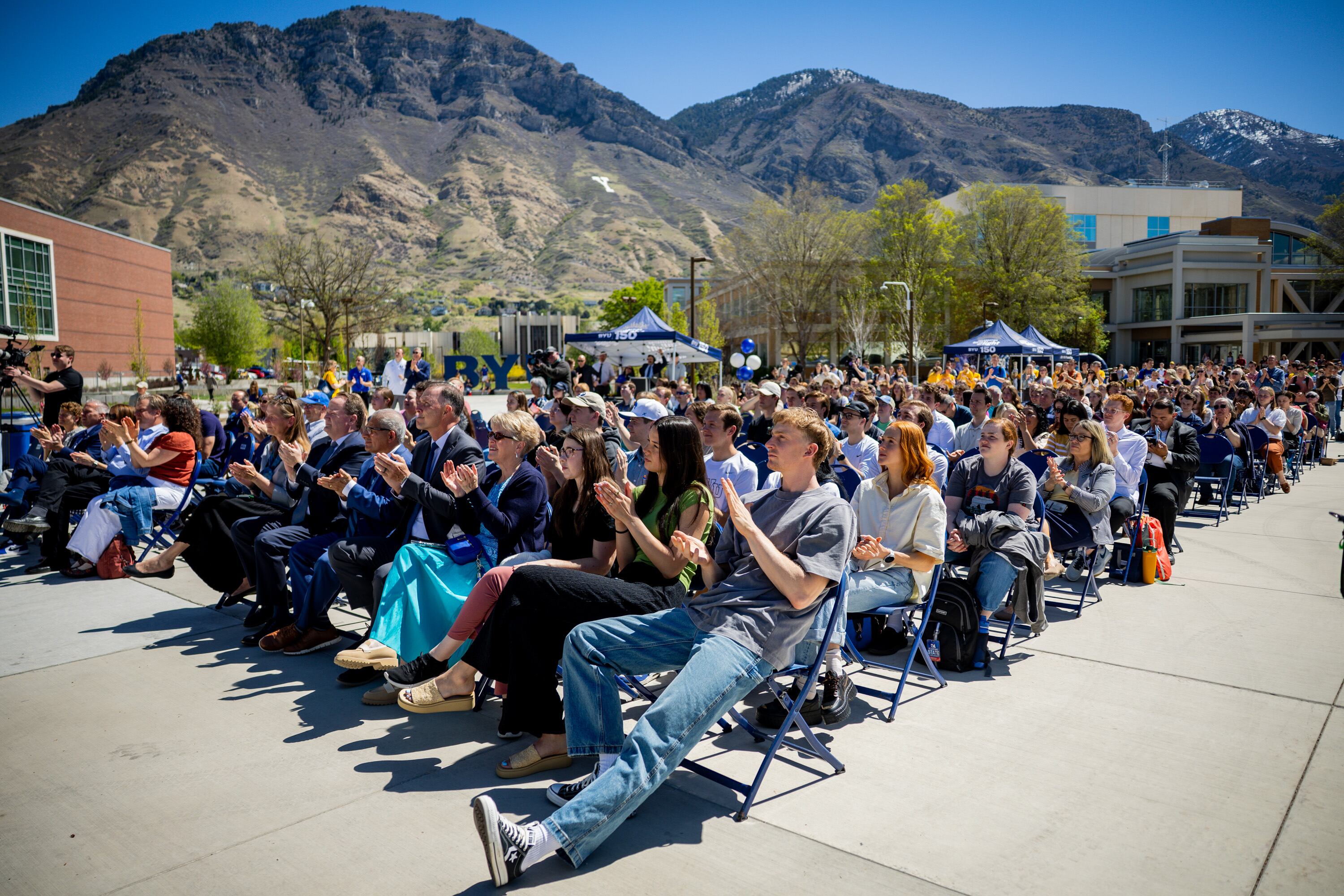 BYU basketball player Richie Saunders and other BYU students attend a time capsule packing party as part of BYU’s 150th anniversary celebration at Brigham Square in Provo on Tuesday. The capsule will be opened again in 2075.