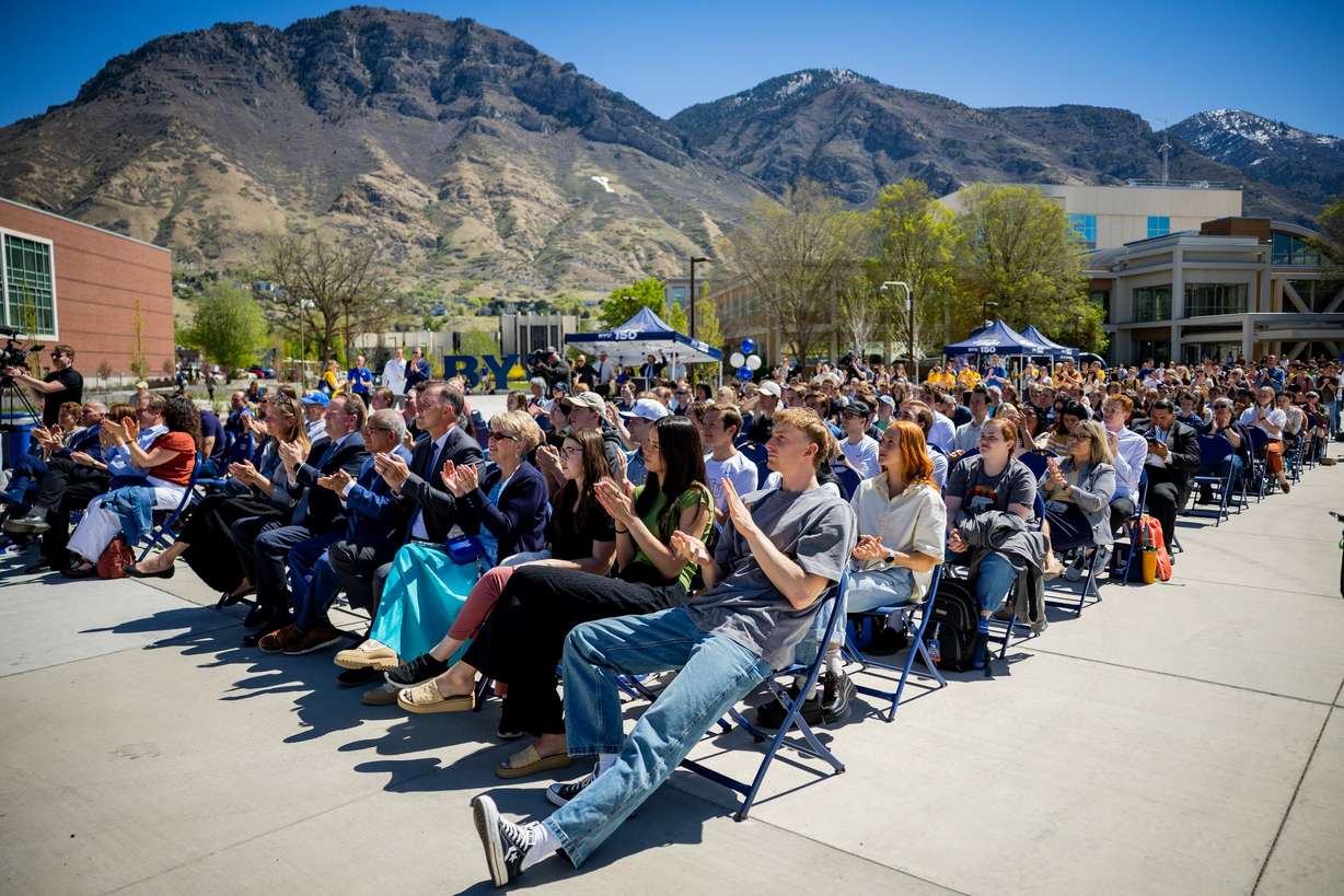 BYU basketball player Richie Saunders and other BYU students attend a time capsule packing party as part of BYU’s 150th anniversary celebration at Brigham Square in Provo on Tuesday. The capsule will be opened again in 2075.