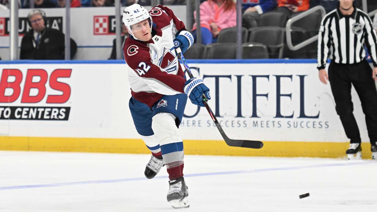 Colorado Avalanche's Josh Manson (42) takes a shot against the St. Louis Blues during the third period of an NHL hockey game, Tuesday, April 7, 2026, in St. Louis.