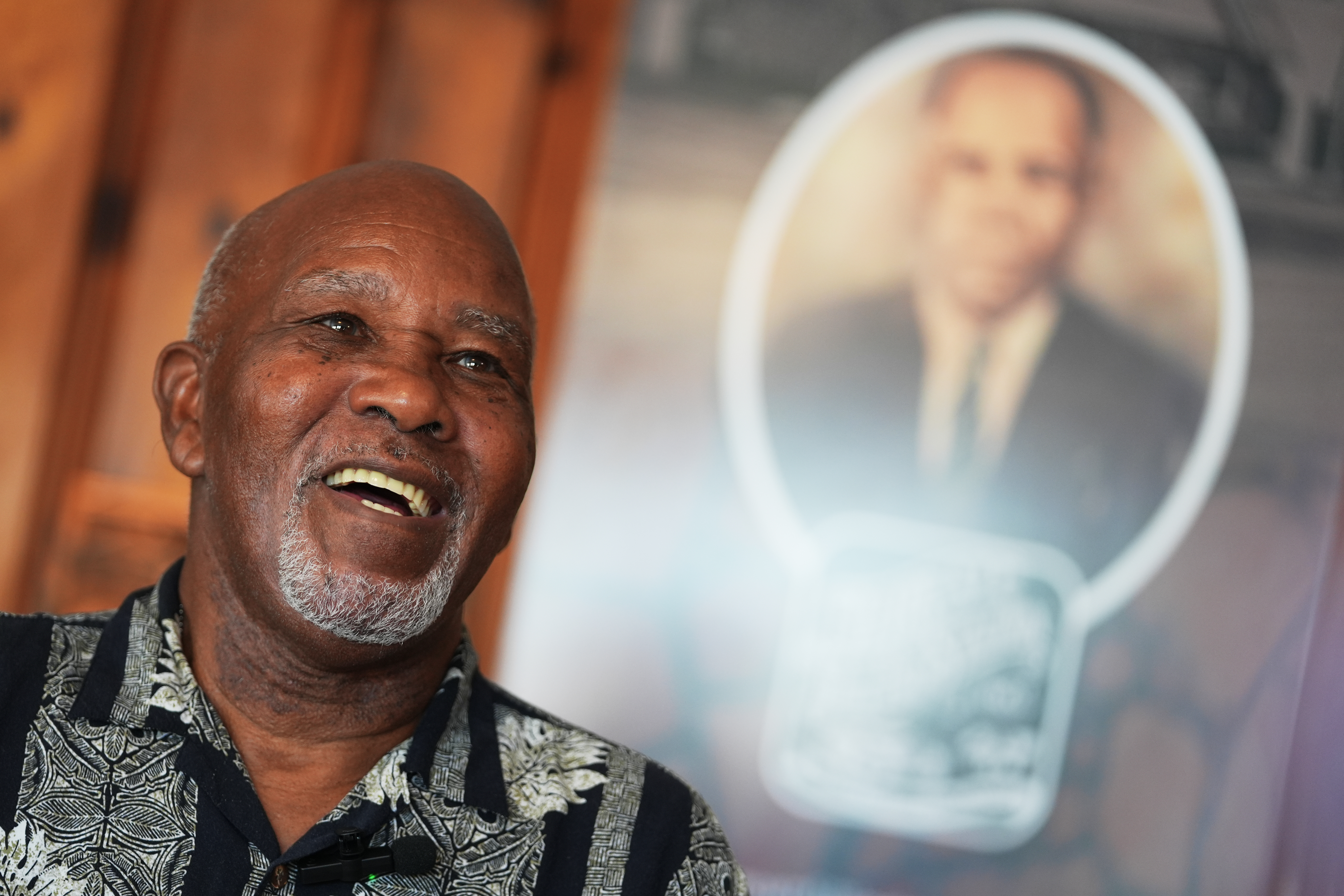 Edward Threatt, speaking in front of a photograph of his grandfather Allen Threatt Sr., is interviewed at the Threatt Filling Station along Route 66 in Luther, Okla., Nov. 19. The Threatt Filling Station is the only known Black-owned business along the route.