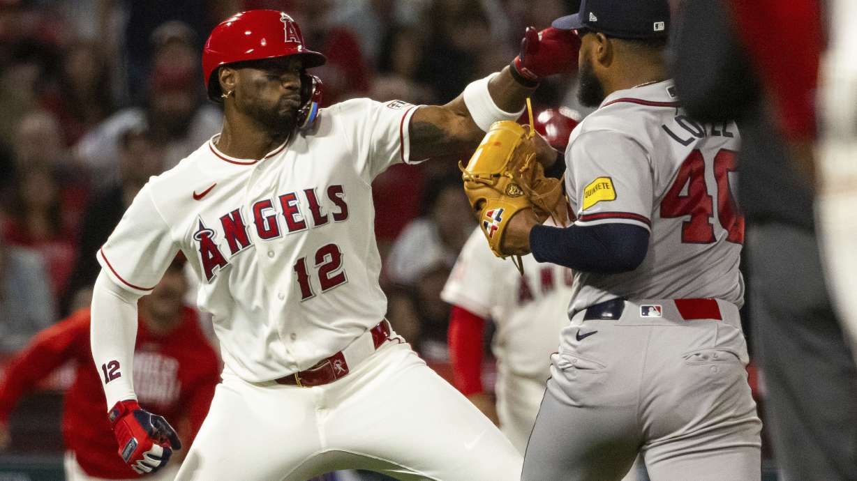 Los Angeles Angels' Jorge Soler (12) and Atlanta Braves' Reynaldo López (40) fight during the fifth inning of a baseball game, Tuesday, April 7, 2026, in Anaheim, Calif.
