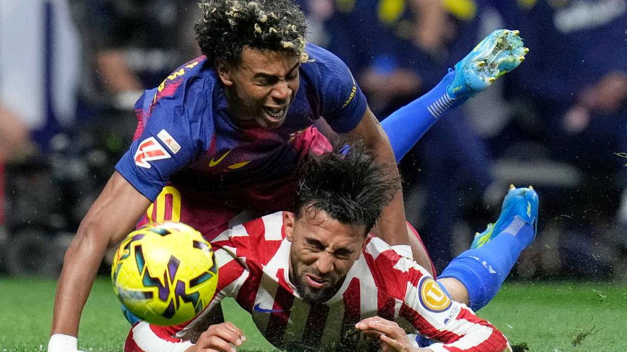 Barcelona's Lamine Yamal, top, is tackled and fouled by Atletico Madrid's Nico Gonzalez, who receives a second yellow card and is then sent off during a La Liga soccer match between Atletico Madrid and Barcelona in Madrid, Spain, Saturday, April 4, 2026.