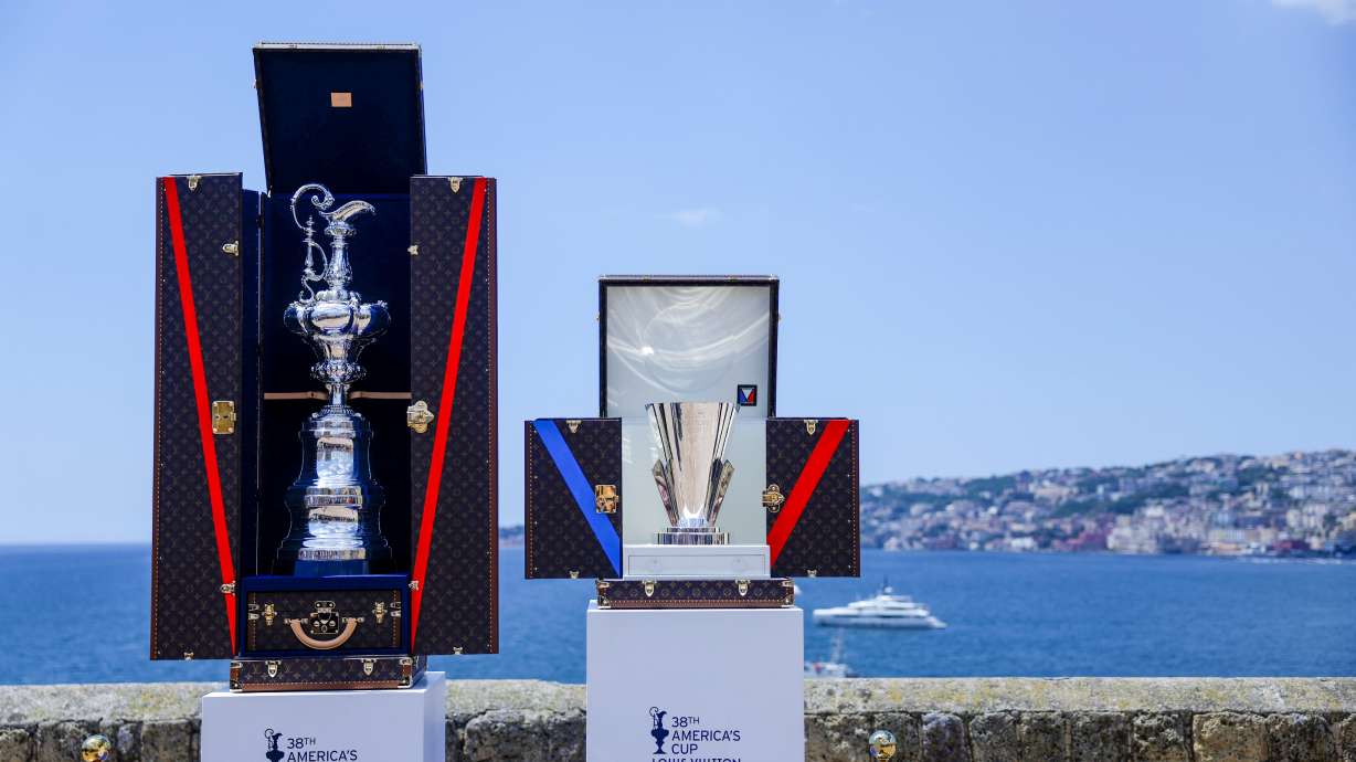 FILE - The America's Cup trophy, left, and Louis Vuitton Cup trophies are seen during the presentation of the 38th America's Cup, at the Castel dell'Ovo in Naples, southern Italy, Wednesday, May 28, 2025. .