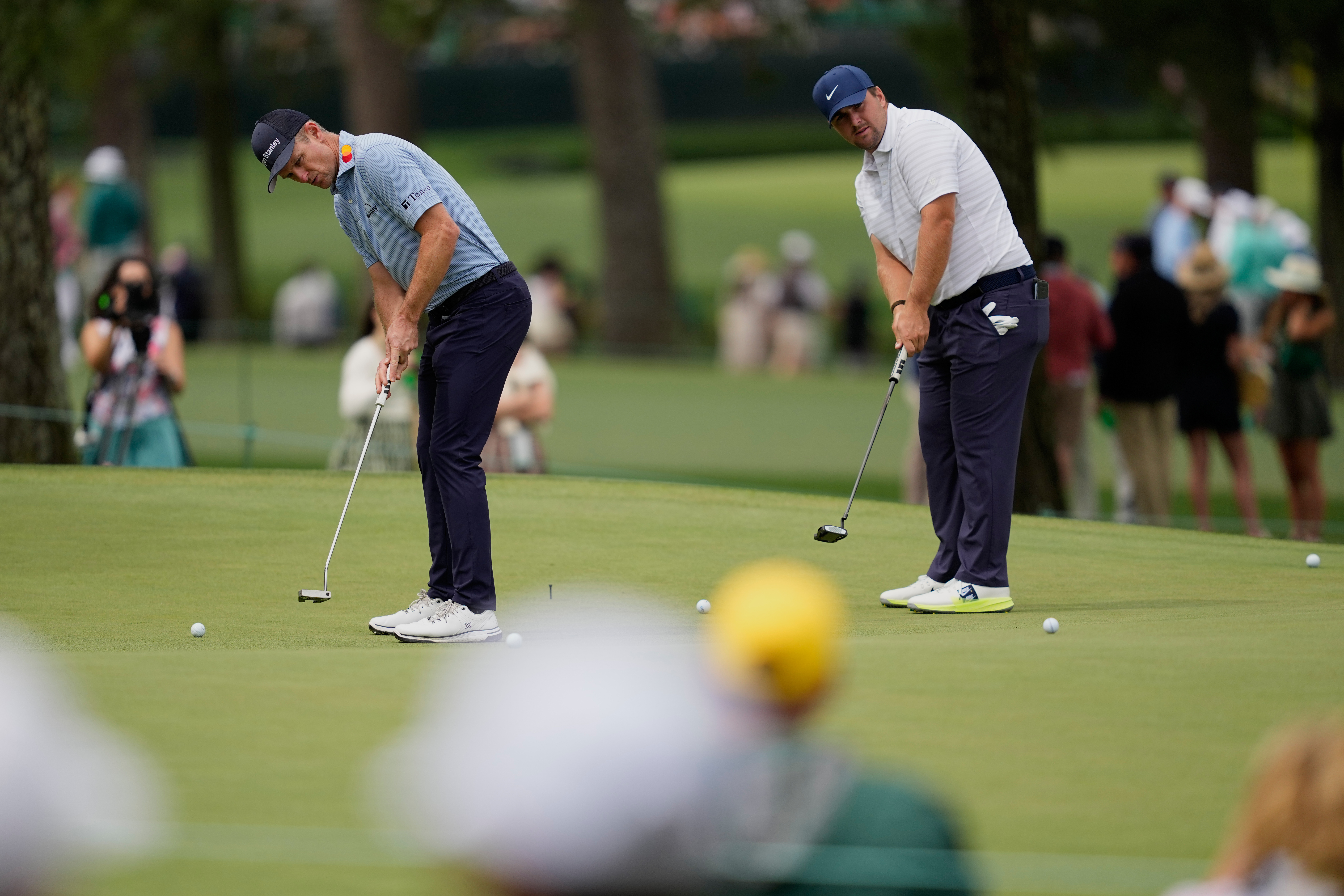 Justin Rose, of England, and Chris Gotterup putt on the seventh hole during a practice round ahead of the Masters golf tournament at the Augusta National Golf Club, Monday, April 6, 2026, in Augusta, Ga.