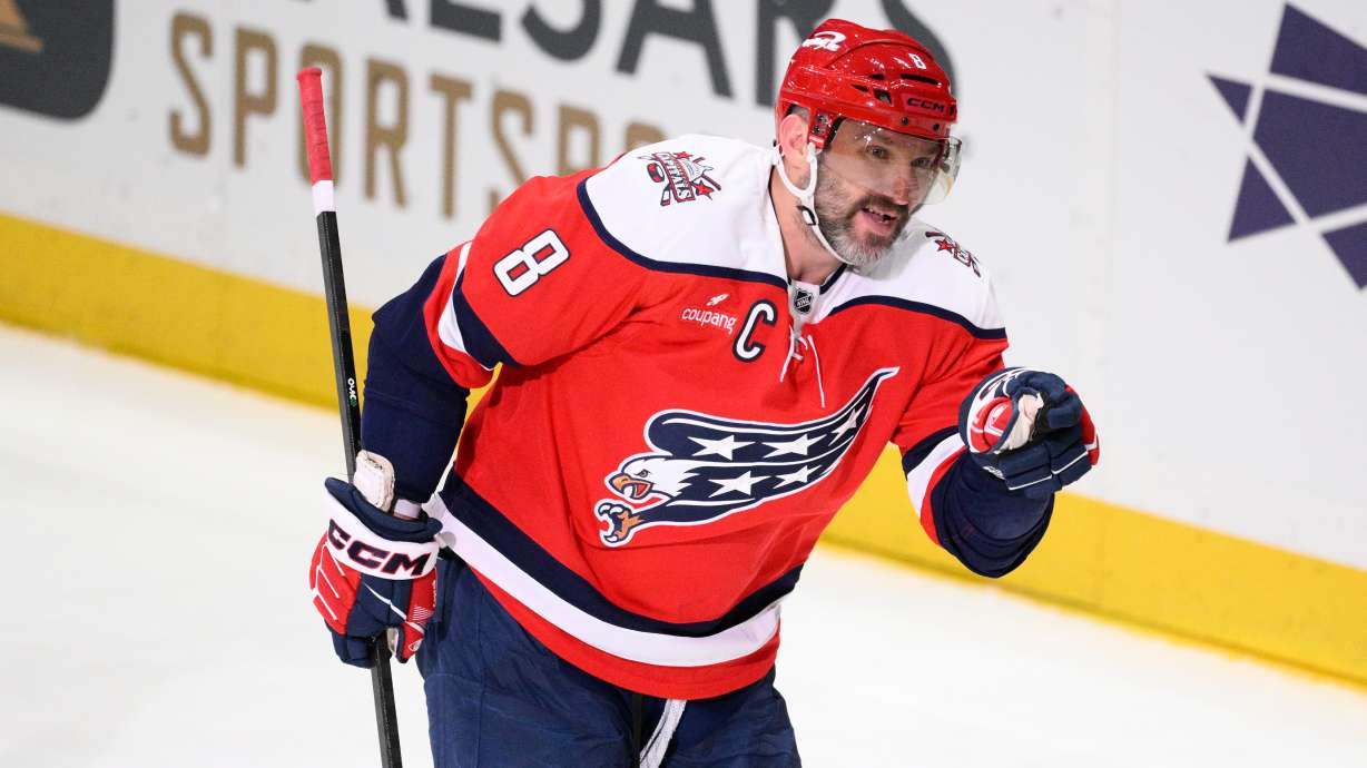 Washington Capitals left wing Alex Ovechkin motions to the crowd after he scored his 1,000th career goal combining regular season and playoffs during the third period of an NHL hockey game against the Colorado Avalanche, Sunday, March 22, 2026, in Washington.
