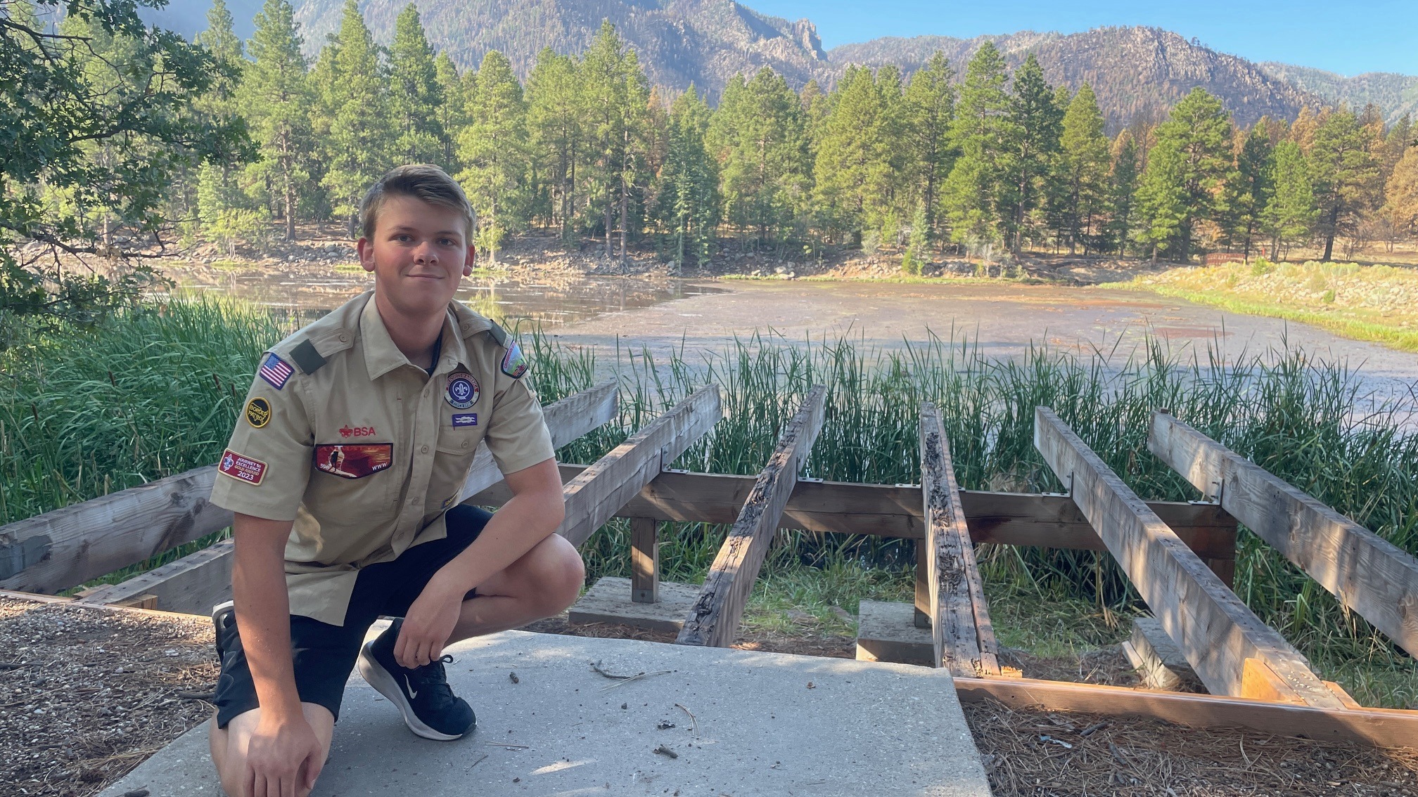 Boston Thiriot poses in the area of Pine Valley that was ravaged by the Forsyth Fire last summer, where he helped rebuild a dock.
